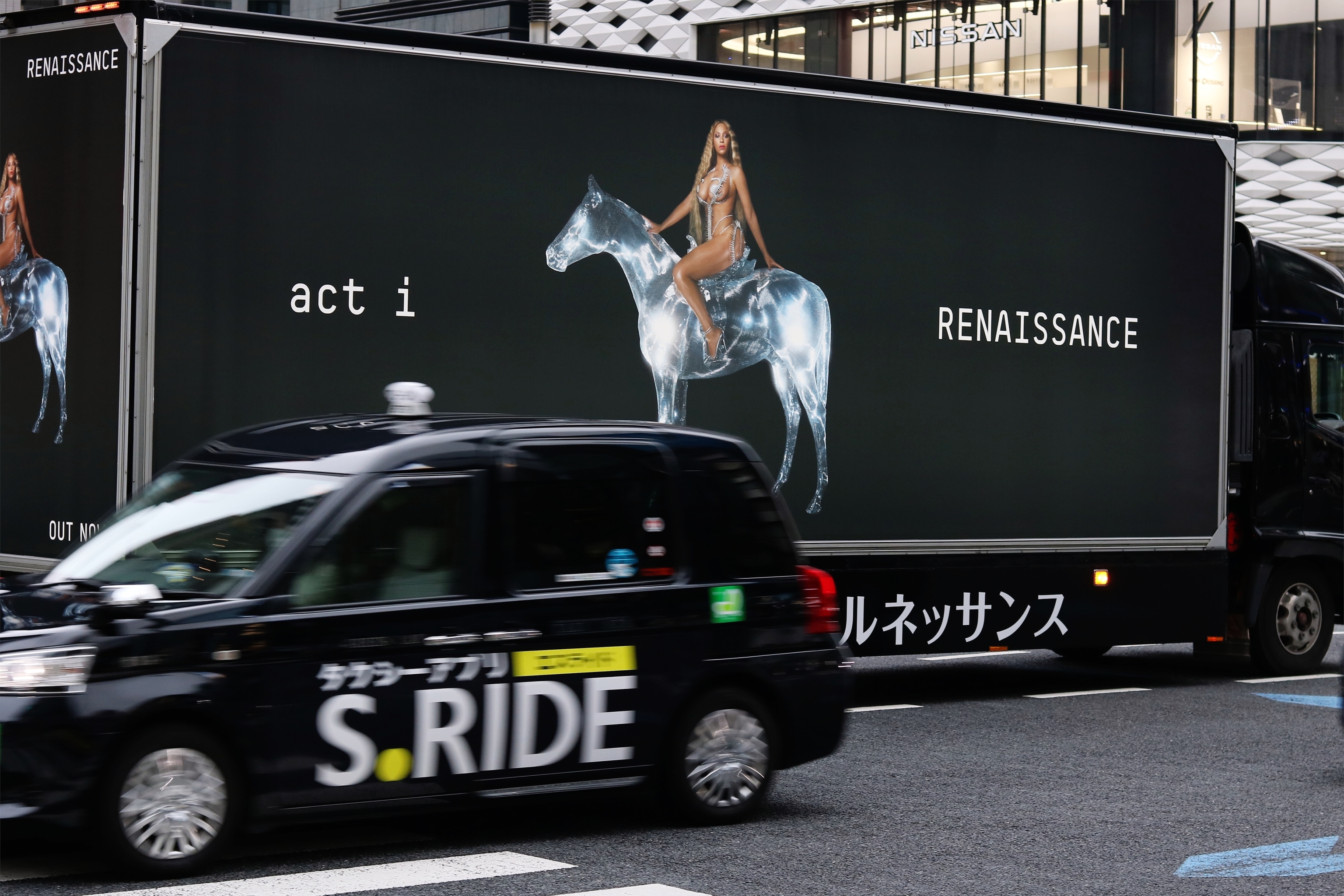 A taxi passes a truck promoting Beyonce's album 'Renaissance' in Tokyo.
