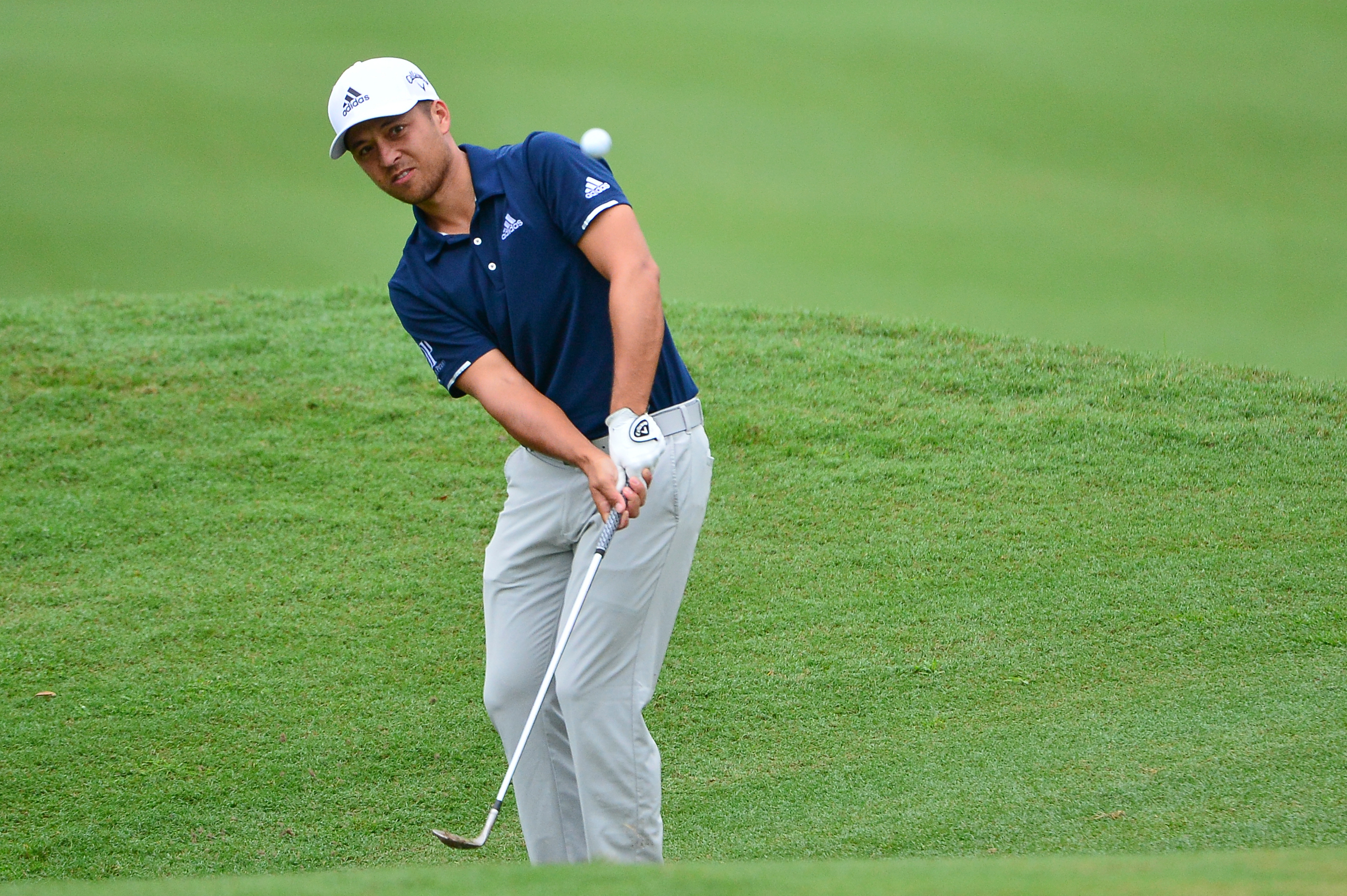 Xander Schauffele makes a shot during a tournament.