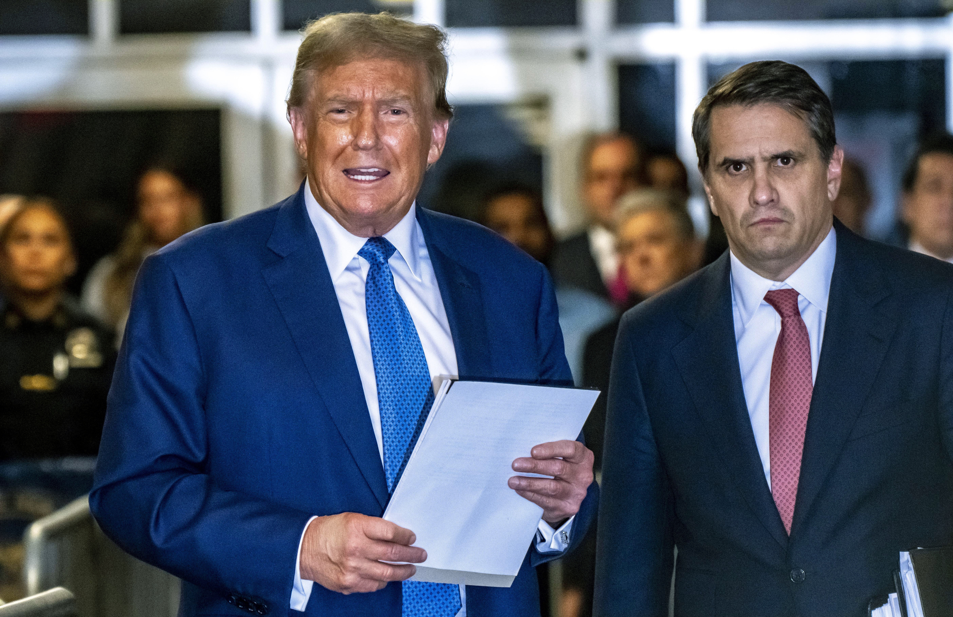 Former President Donald Trump speaks to the media, alongside attorney Todd Blanche.