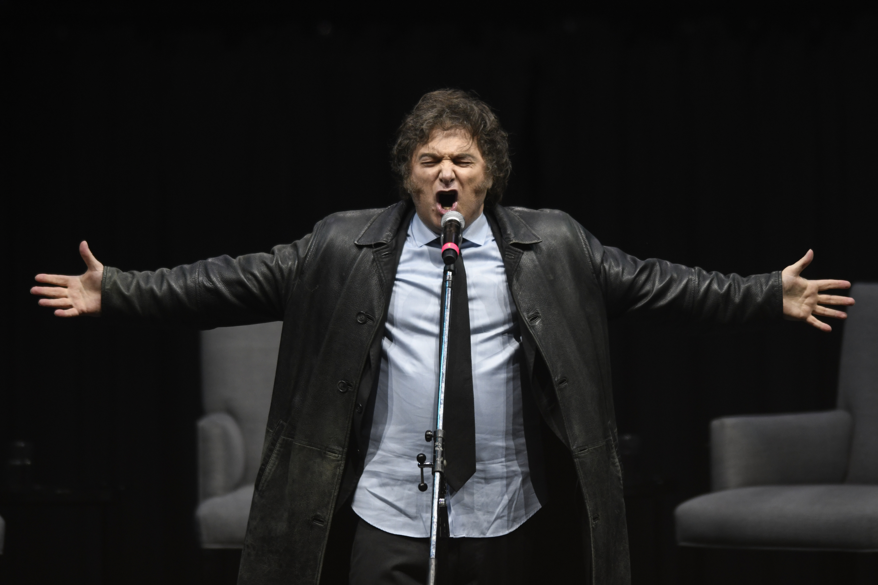 Argentine President Javier Milei sings at a promotional event for his new book in Buenos Aires.