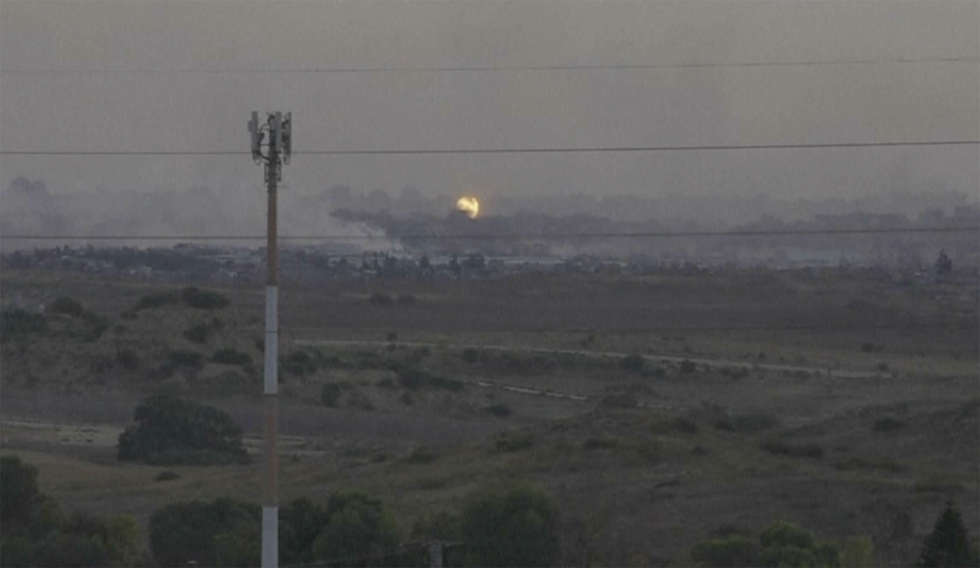 flames and smoke rising from what Palestinian medics say is an Israeli airstrike.