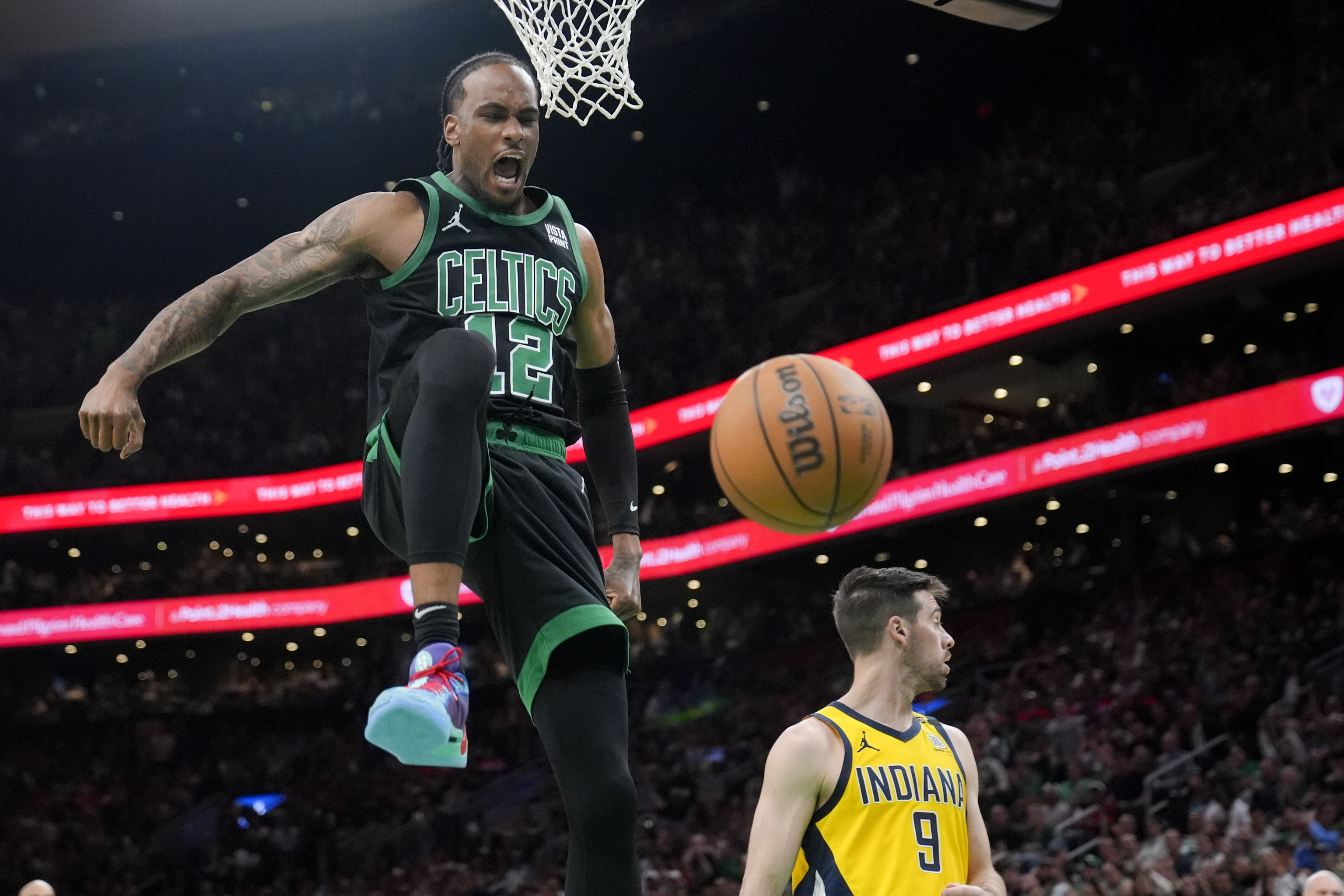 Boston Celtics forward Oshae Brissett (12) celebrates after dunking against the Indiana Pacers