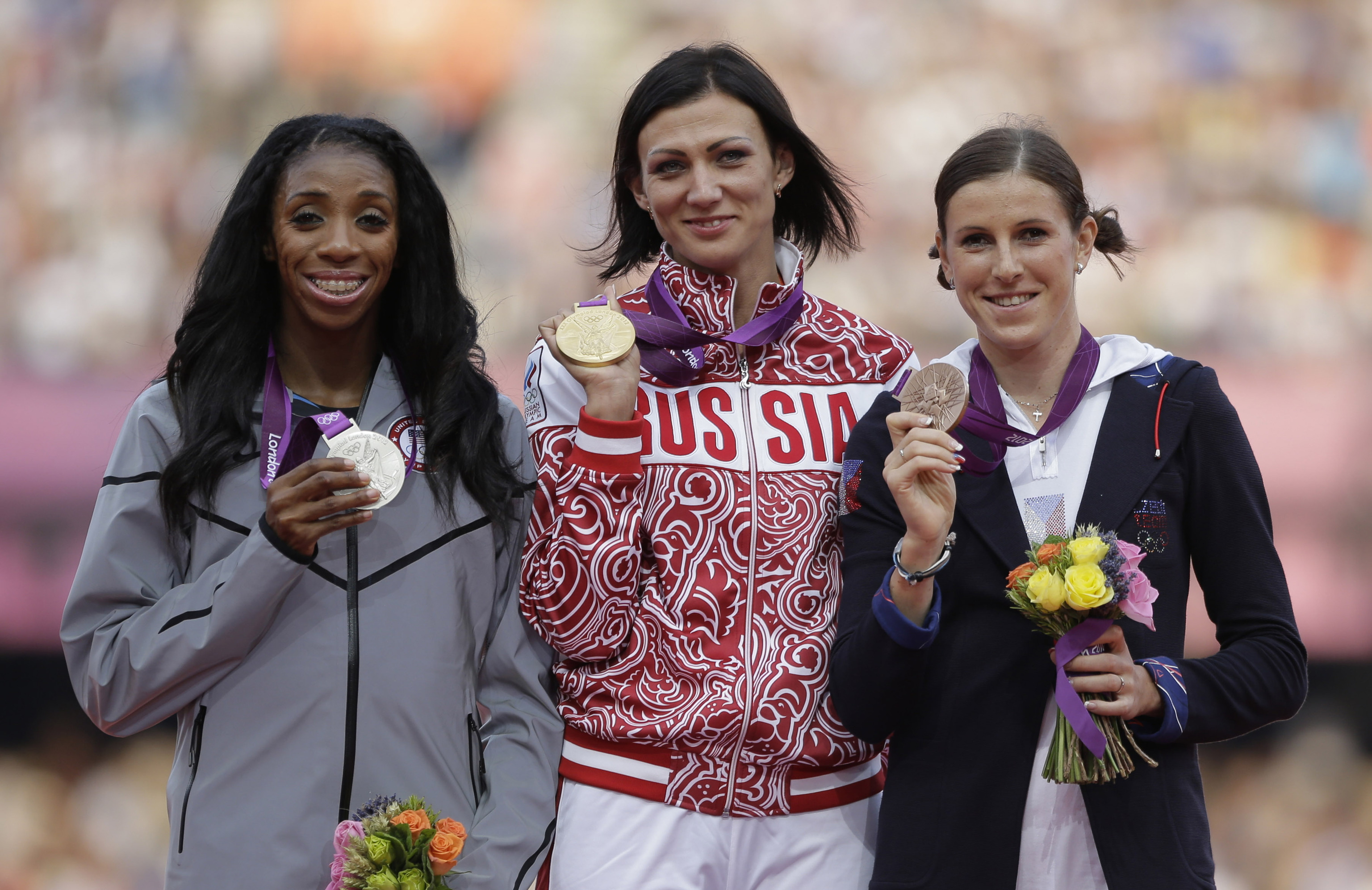 Russia's Natalya Antyukh, middle, holds the gold medal, United States' Lashinda Demus, left, the silver medal, and Czech Republic's Zuzana Hejnova the bronze medal during a ceremony for the women's 400 hurdles in the Olympic Stadium at the Summer Olympics in London,