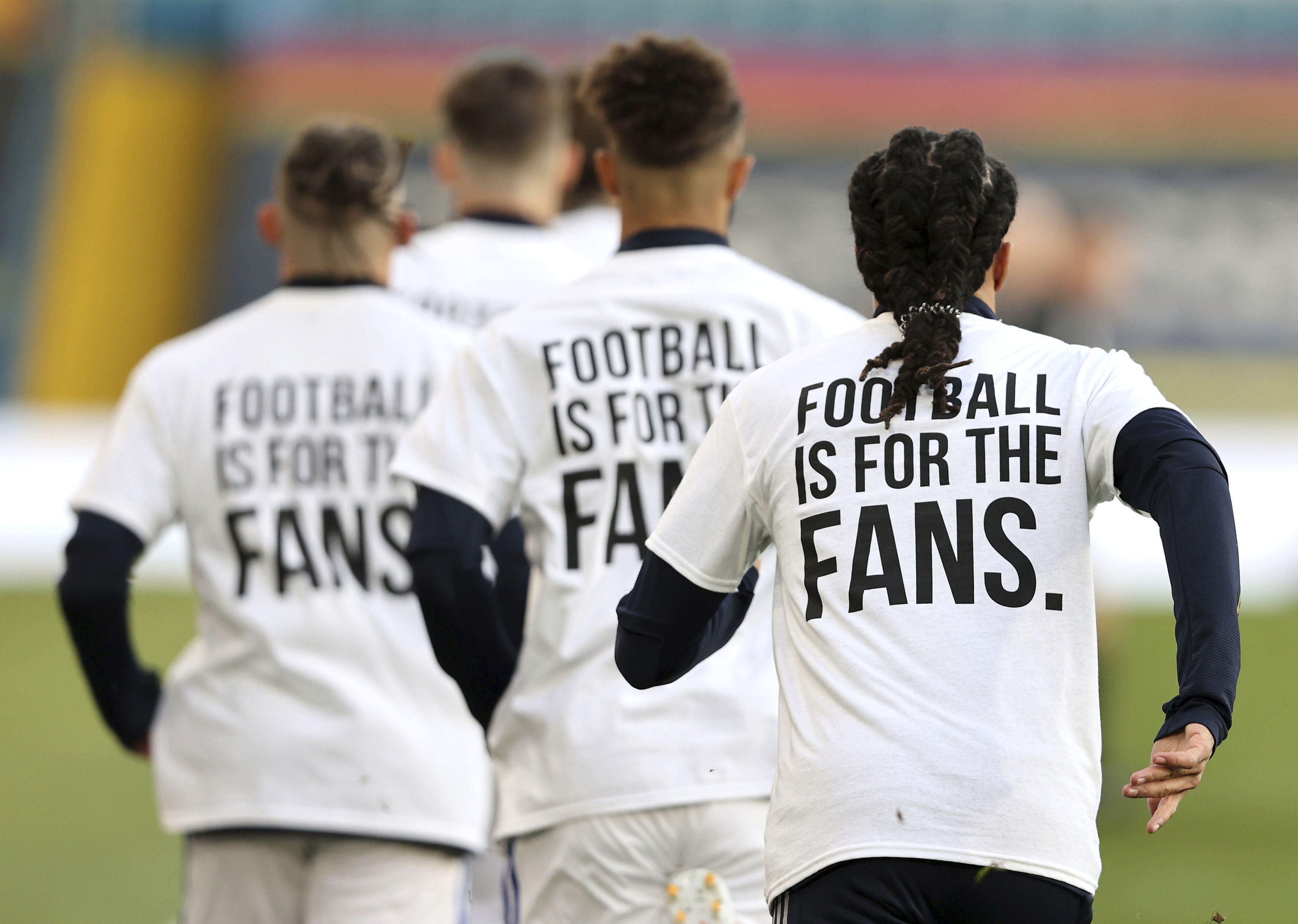 Leeds United players wear t-shirts with the logo 'Football Is For The Fans'