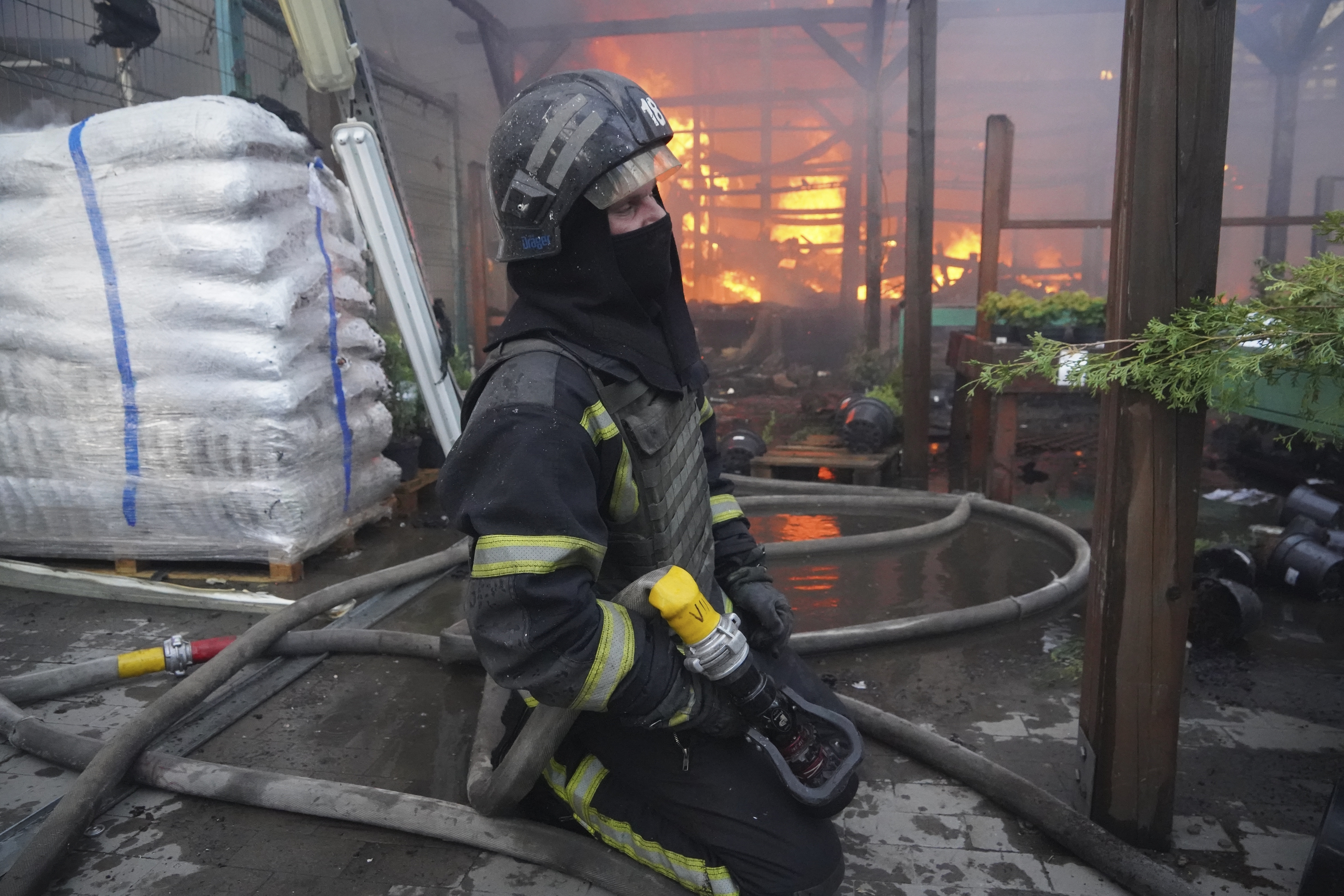 A firefighter puts out a fire caused by a bomb in Kharkiv.