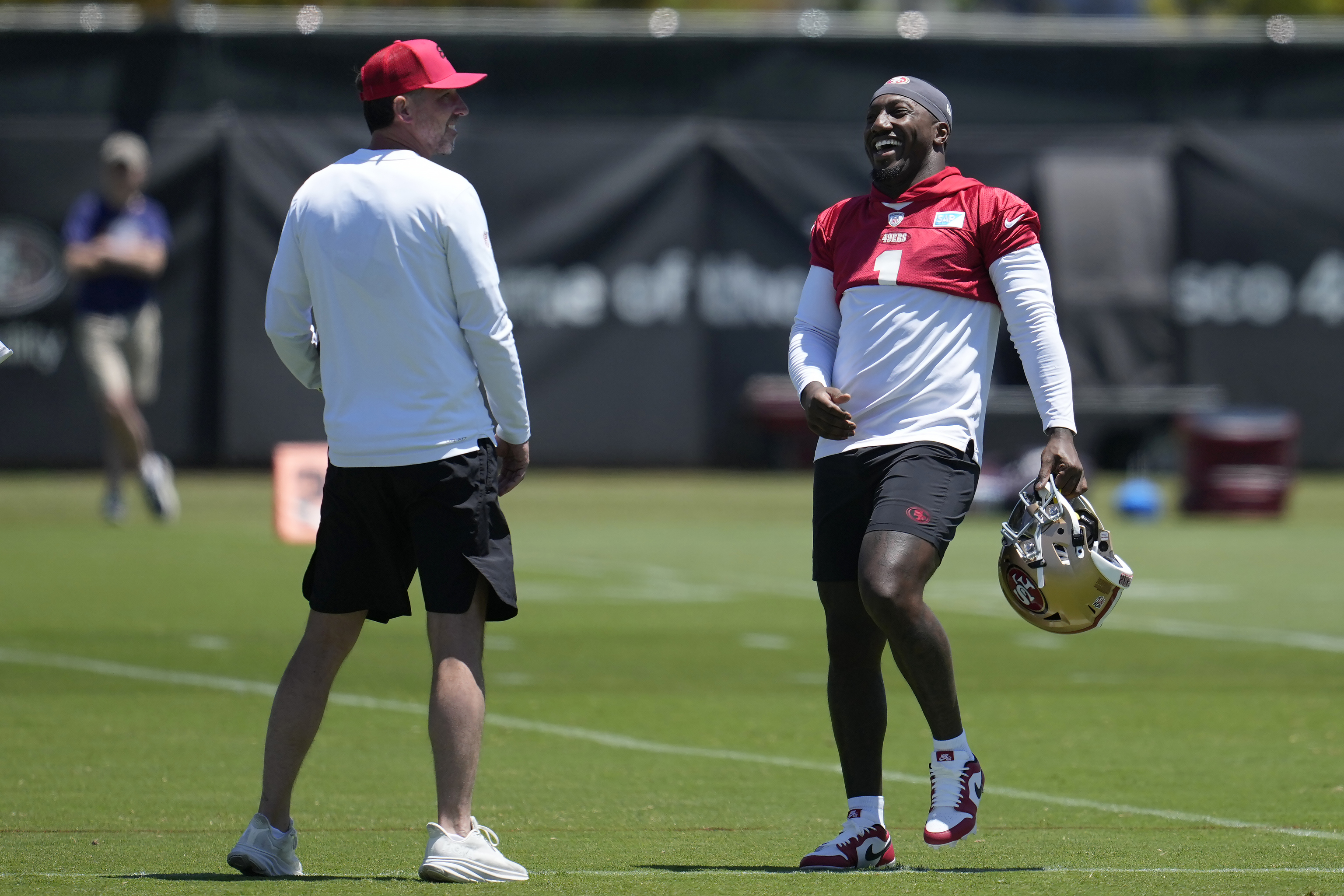 San Francisco 49ers head coach Kyle Shanahan, left, laughs with Deebo Samuel.