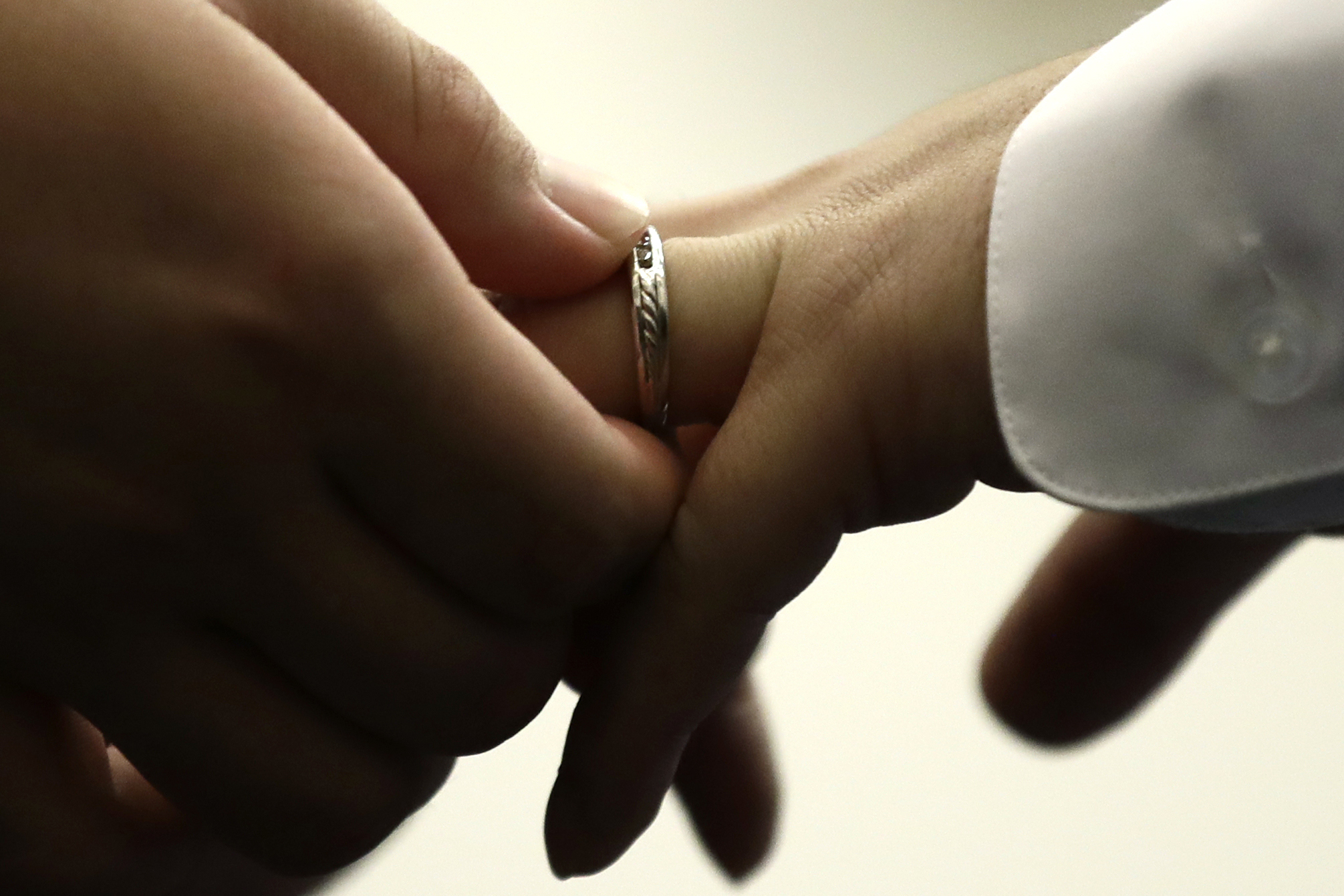 A couple exchanges wedding bands at City Hall in Philadelphia o