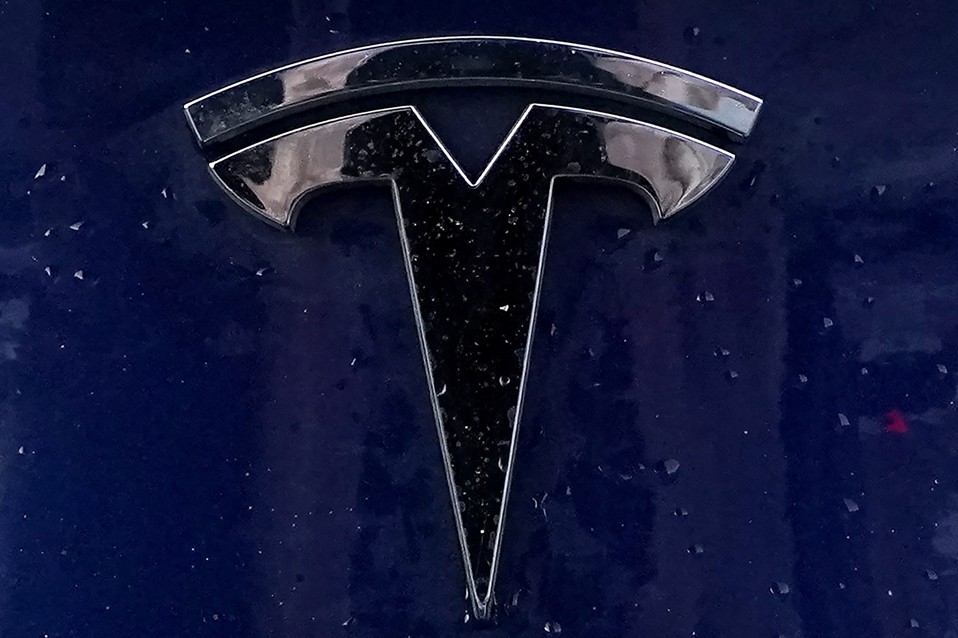 A Tesla electric vehicle emblem.