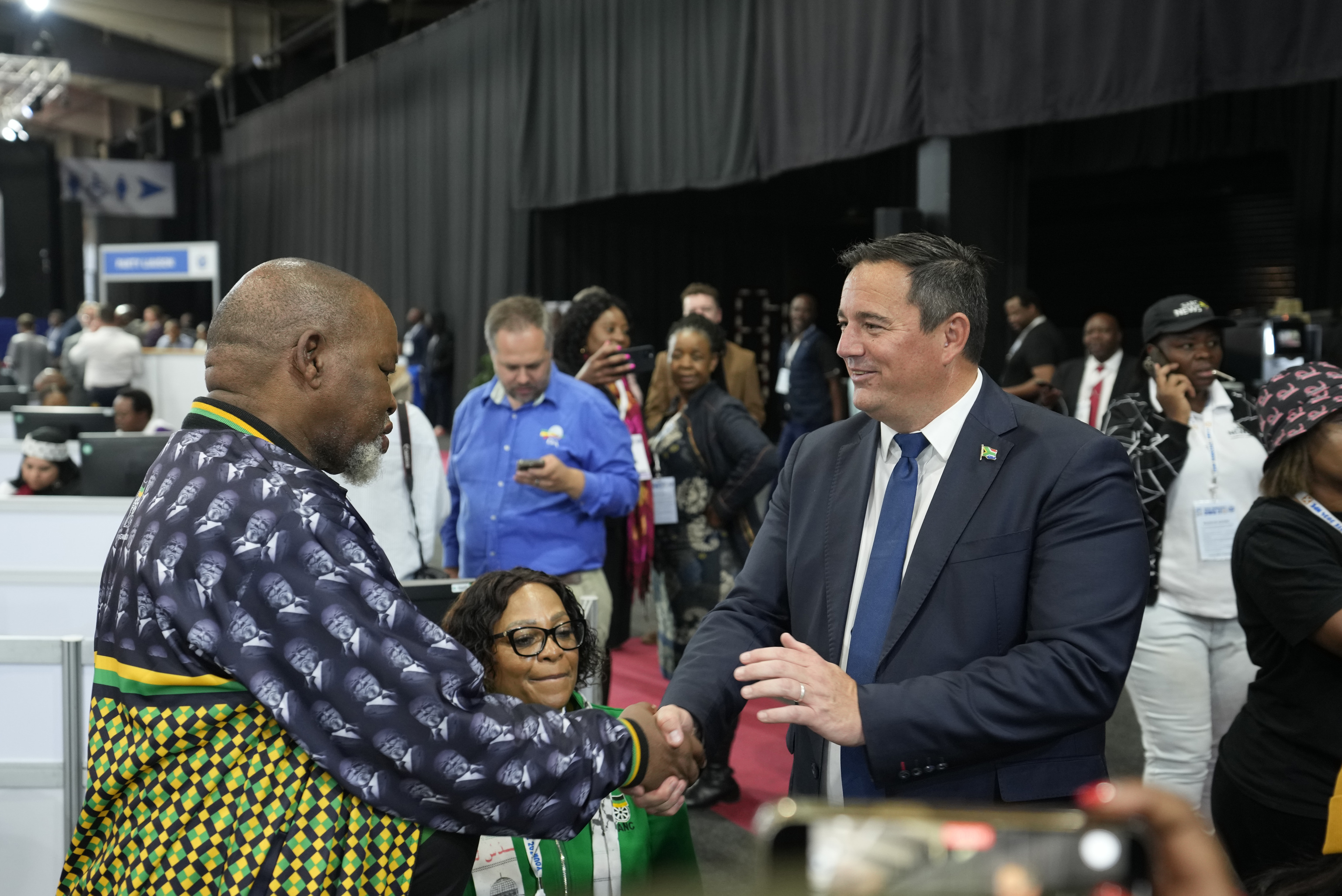 Leader of the main opposition Democratic Alliance John Steenhuisen, right, shakes hands with ANC's Chairman. Gwede Mantashe, left.