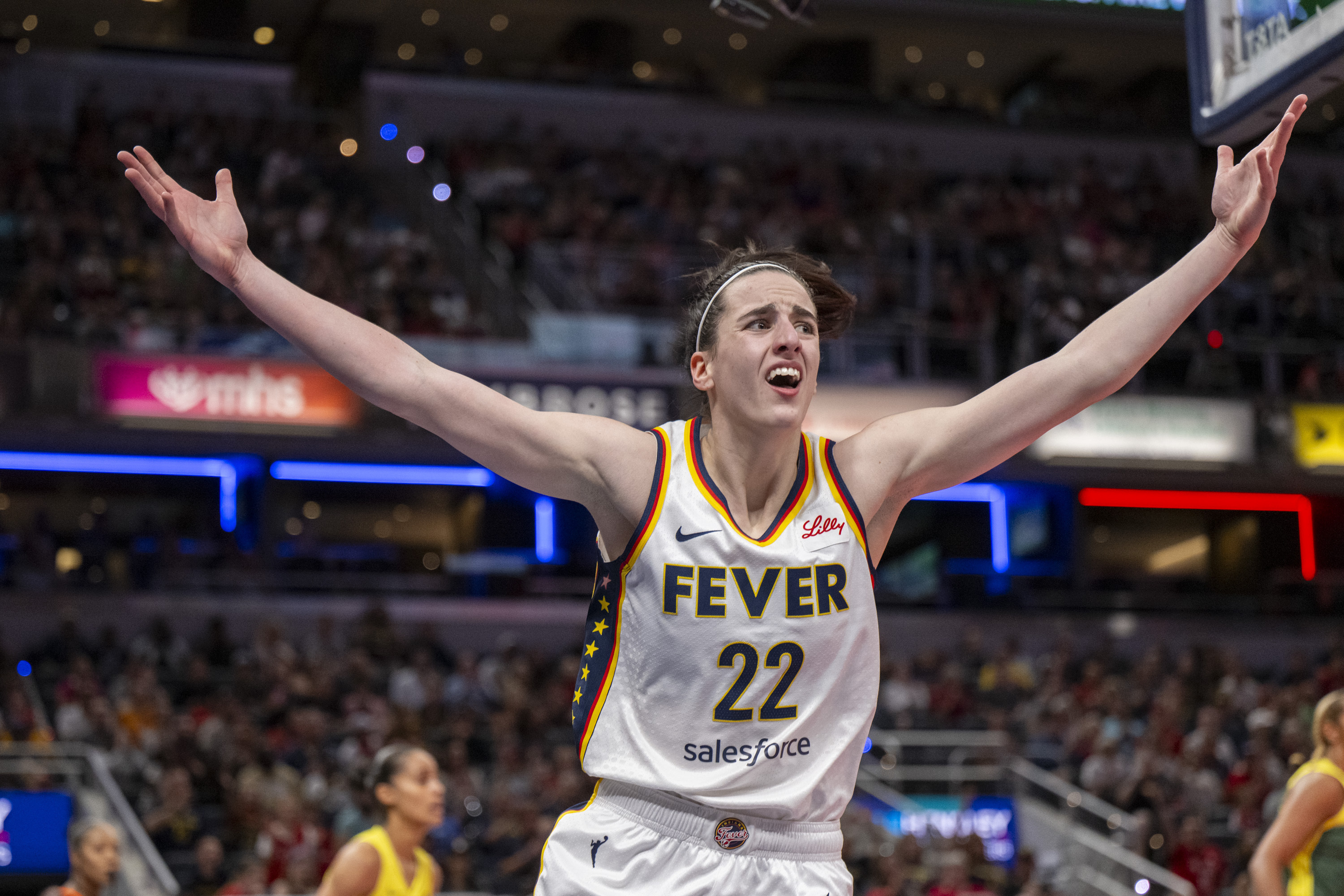 Indiana Fever guard Caitlin Clark reacts after scoring against the Seattle Storm.