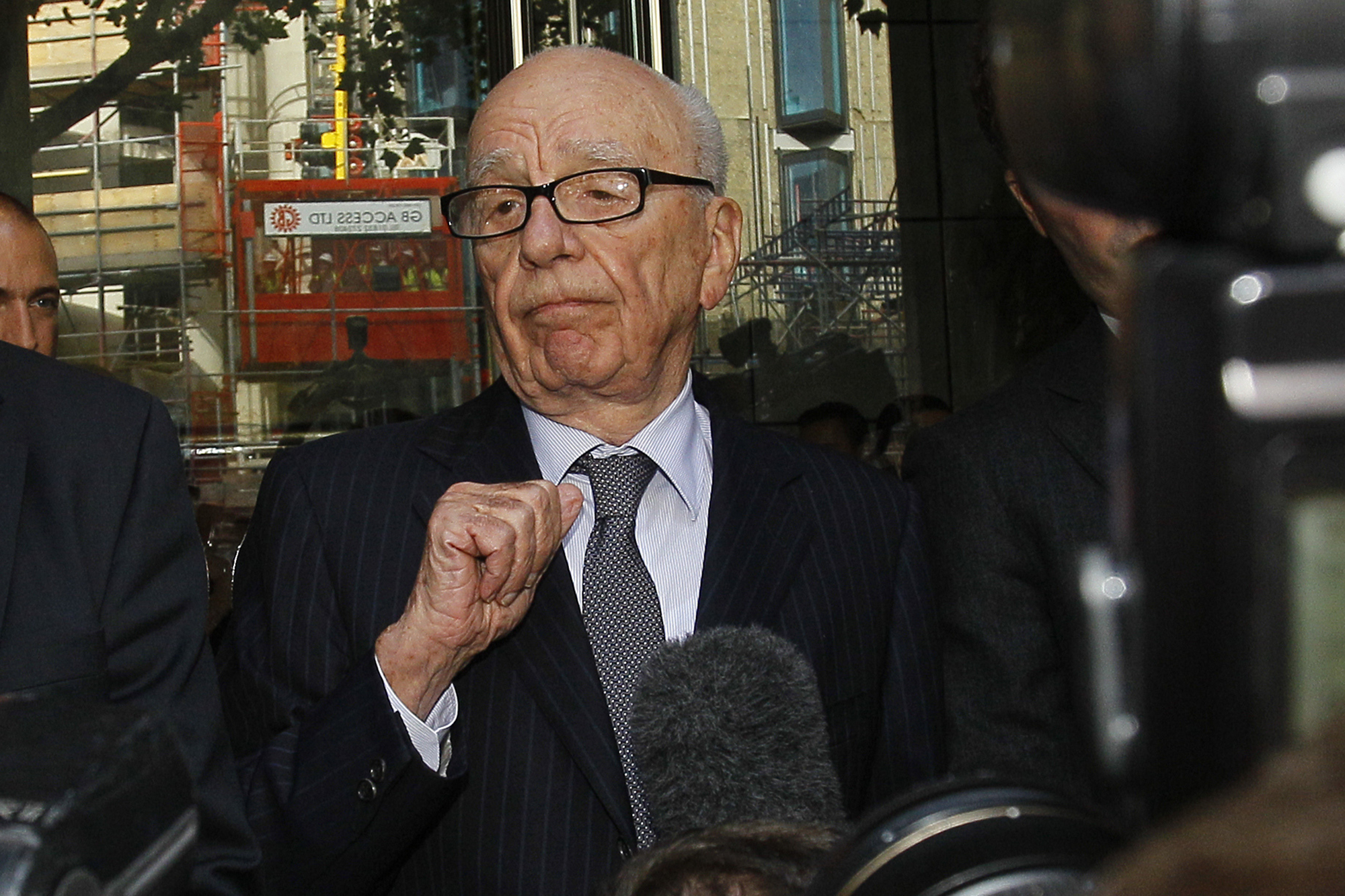 Rupert Murdoch talks with the media in London.