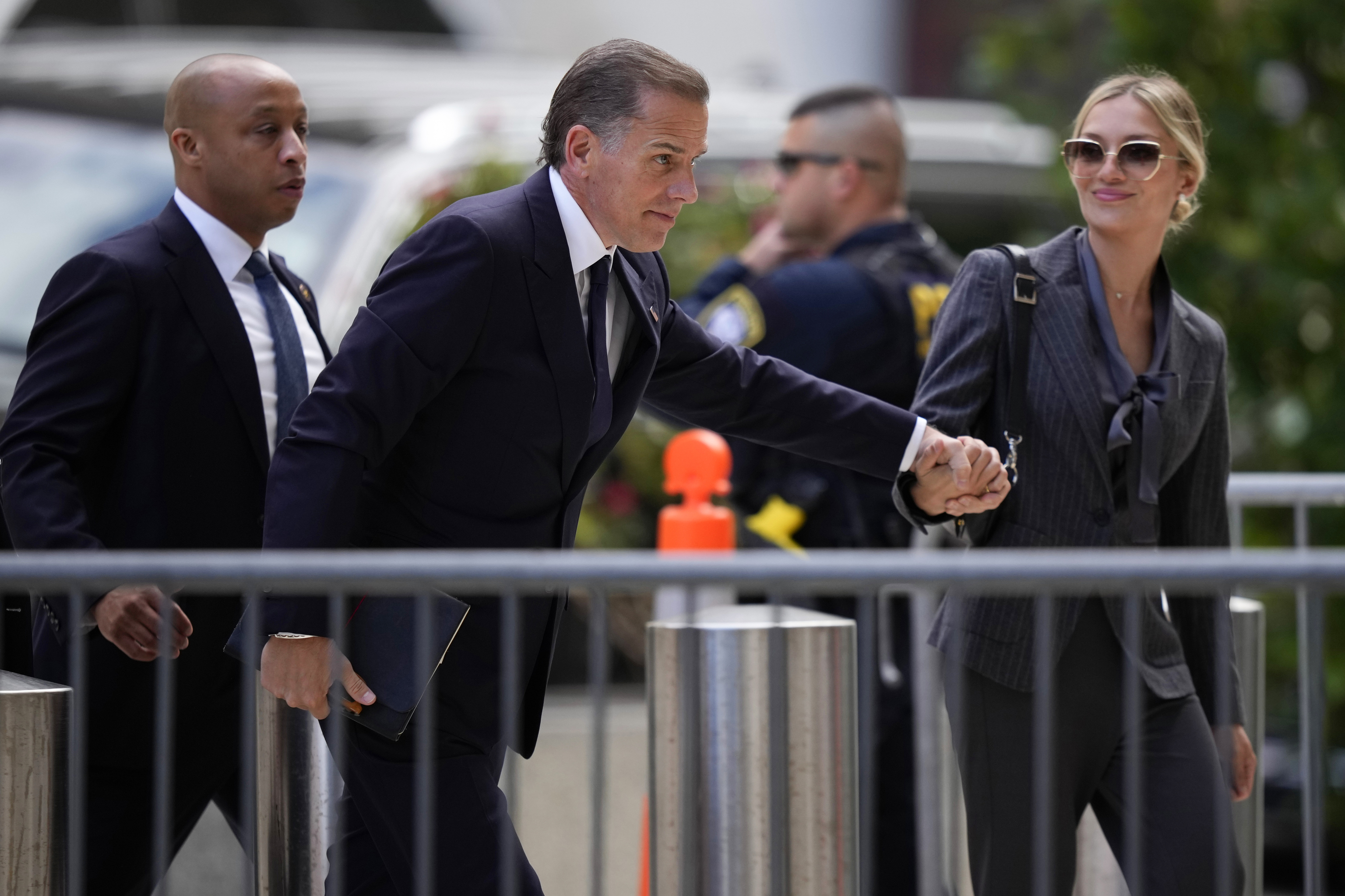 Hunter Biden, center, and his wife, Melissa Cohen Biden, right, arrives at federal court