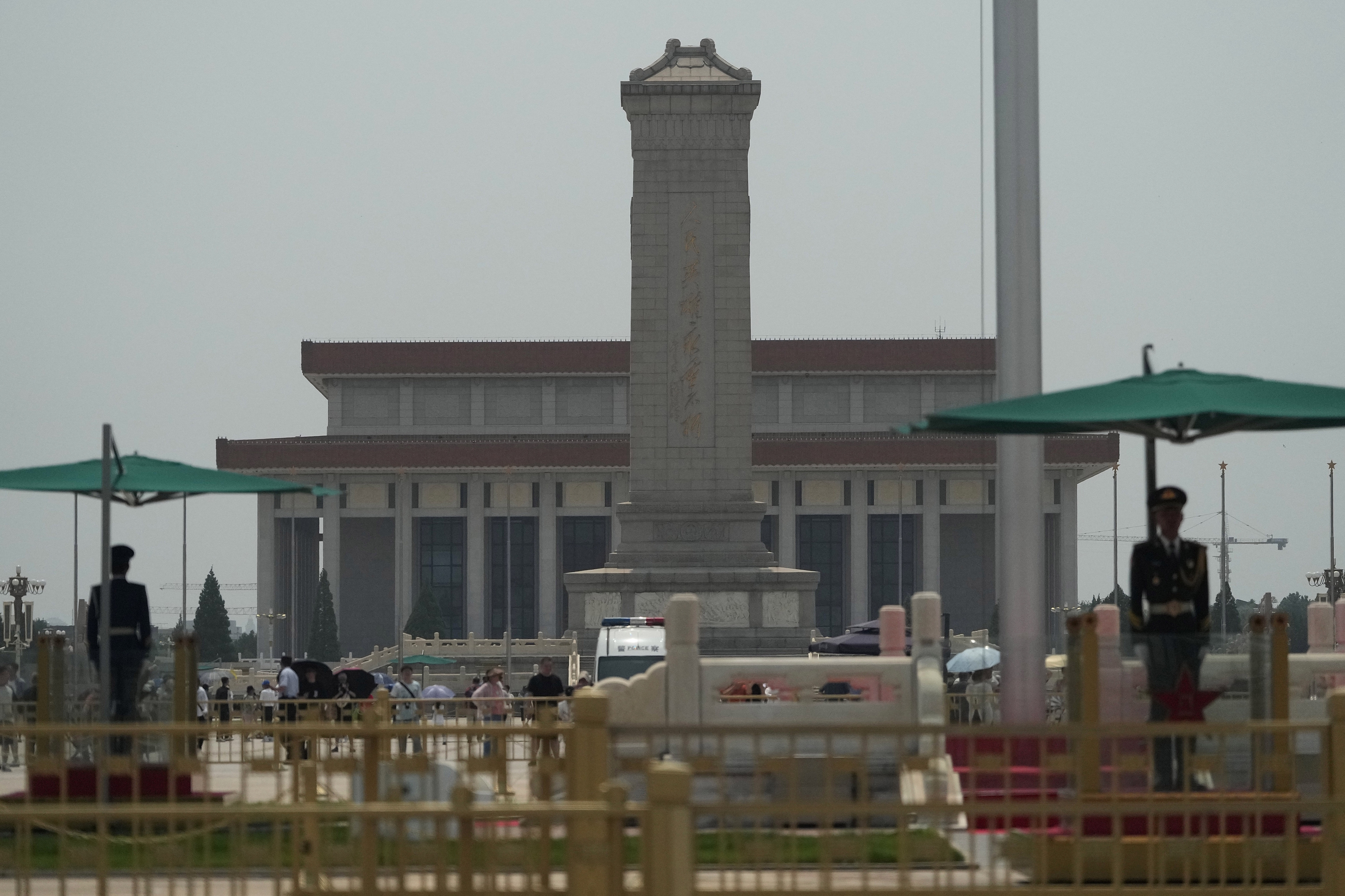 Chinese policemen stand on duty on Tiananmen Square.