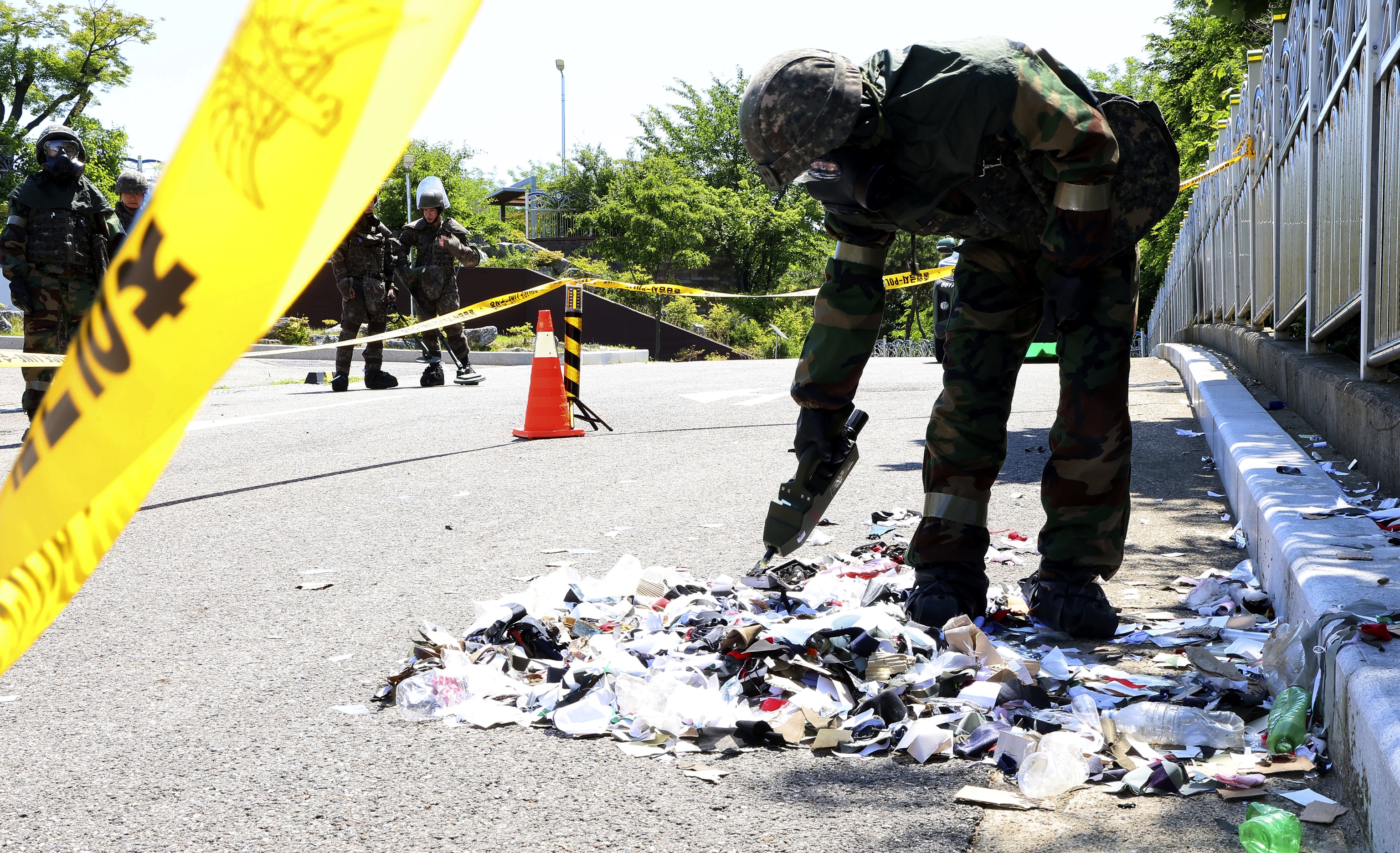 South Korean soldier checks the trash from a balloon.