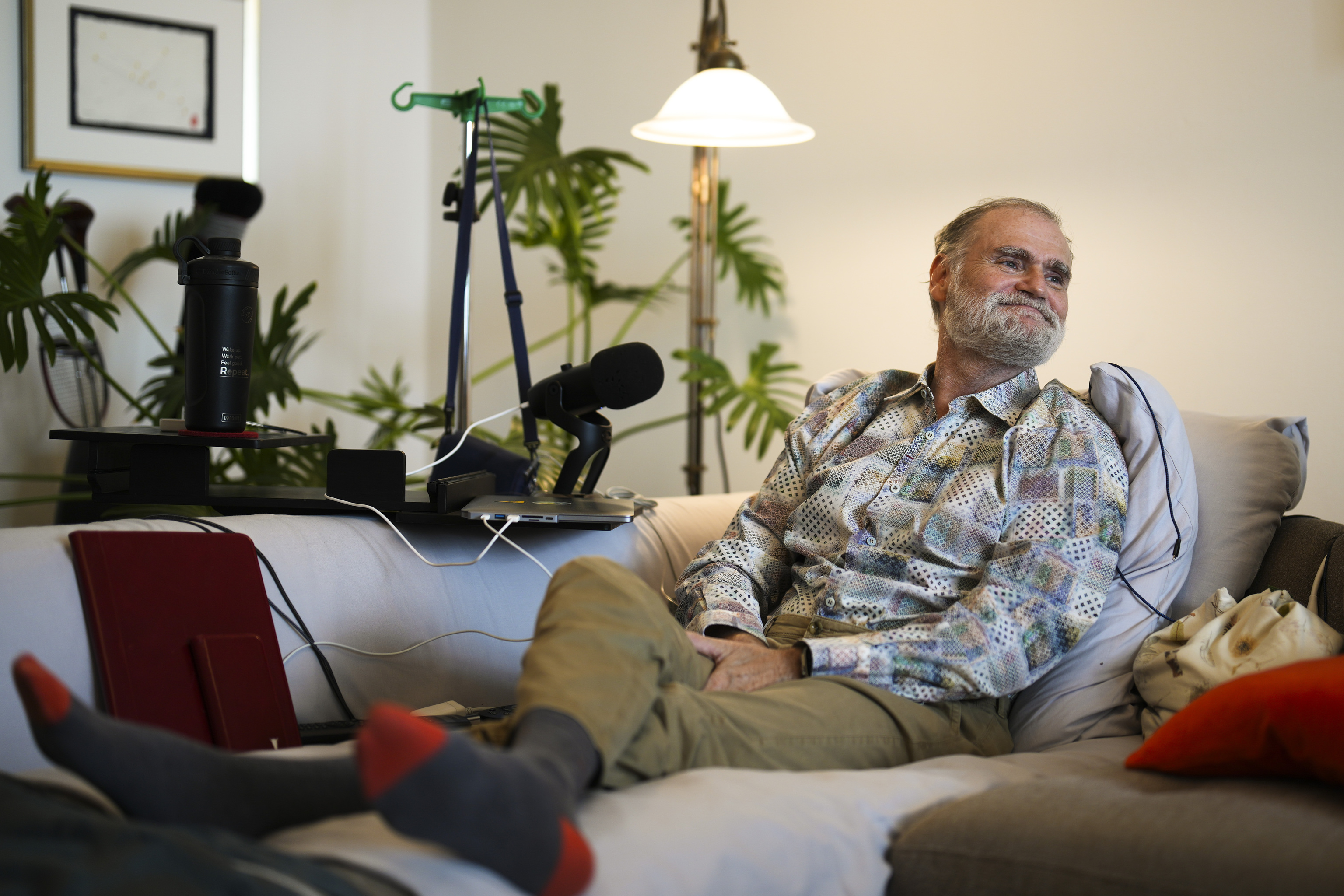 Michael Bommer, who is terminally ill with colon cancer, smiles as he sits on his sofa