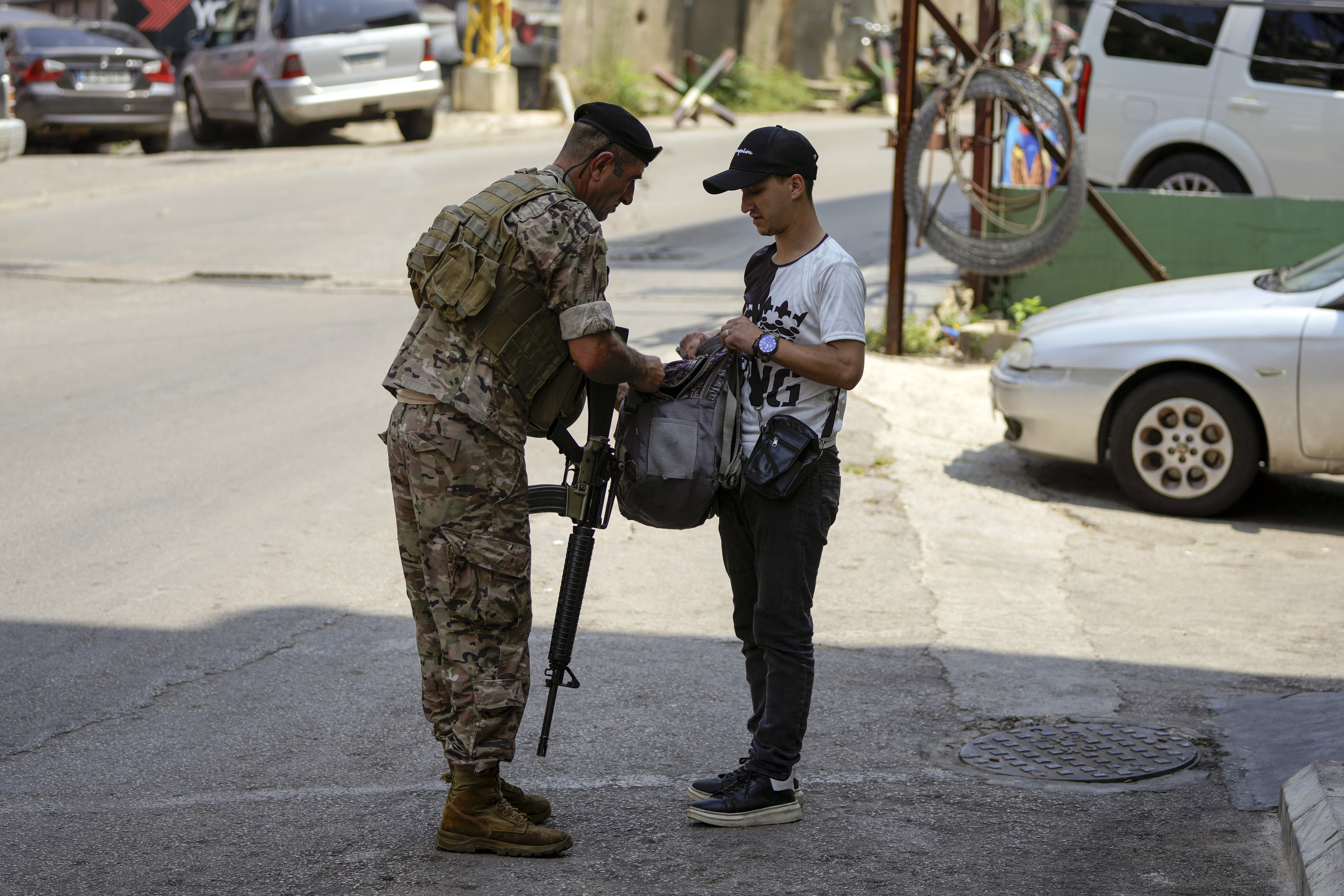 A Lebanese soldier checks a man's luggage on a road leading to the U.S. Embassy.