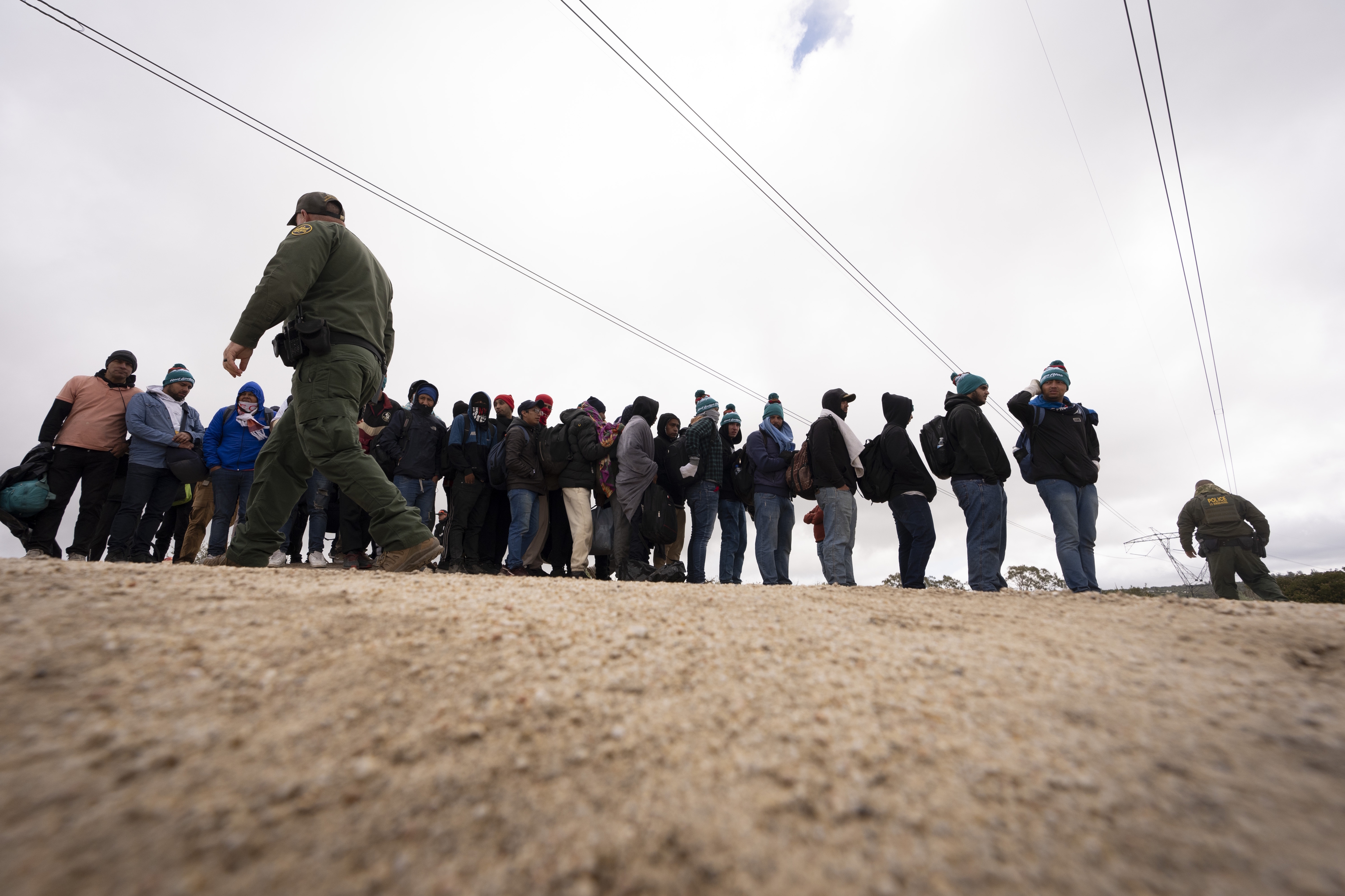 Men seeking asylum after crossing the border with Mexico.