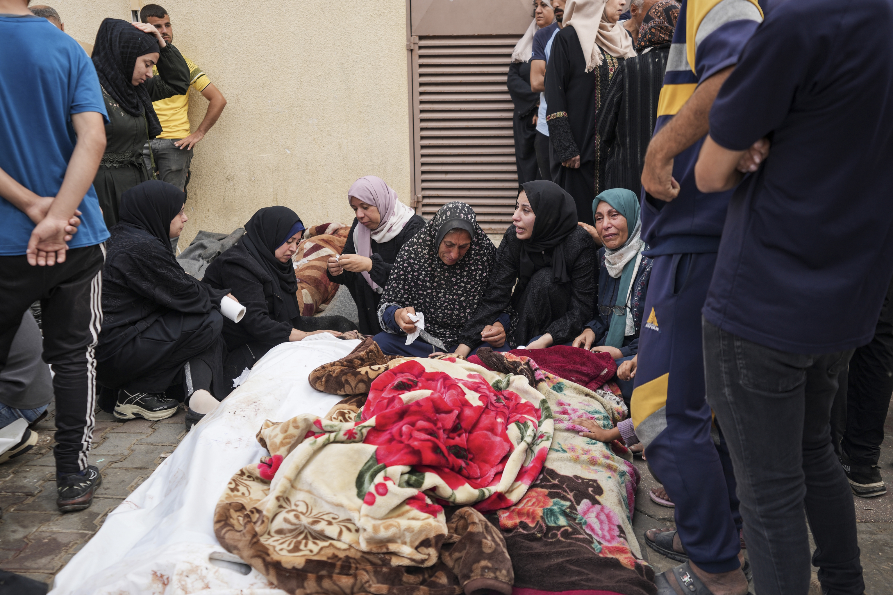 Palestinians mourn relatives killed in an Israeli strike.