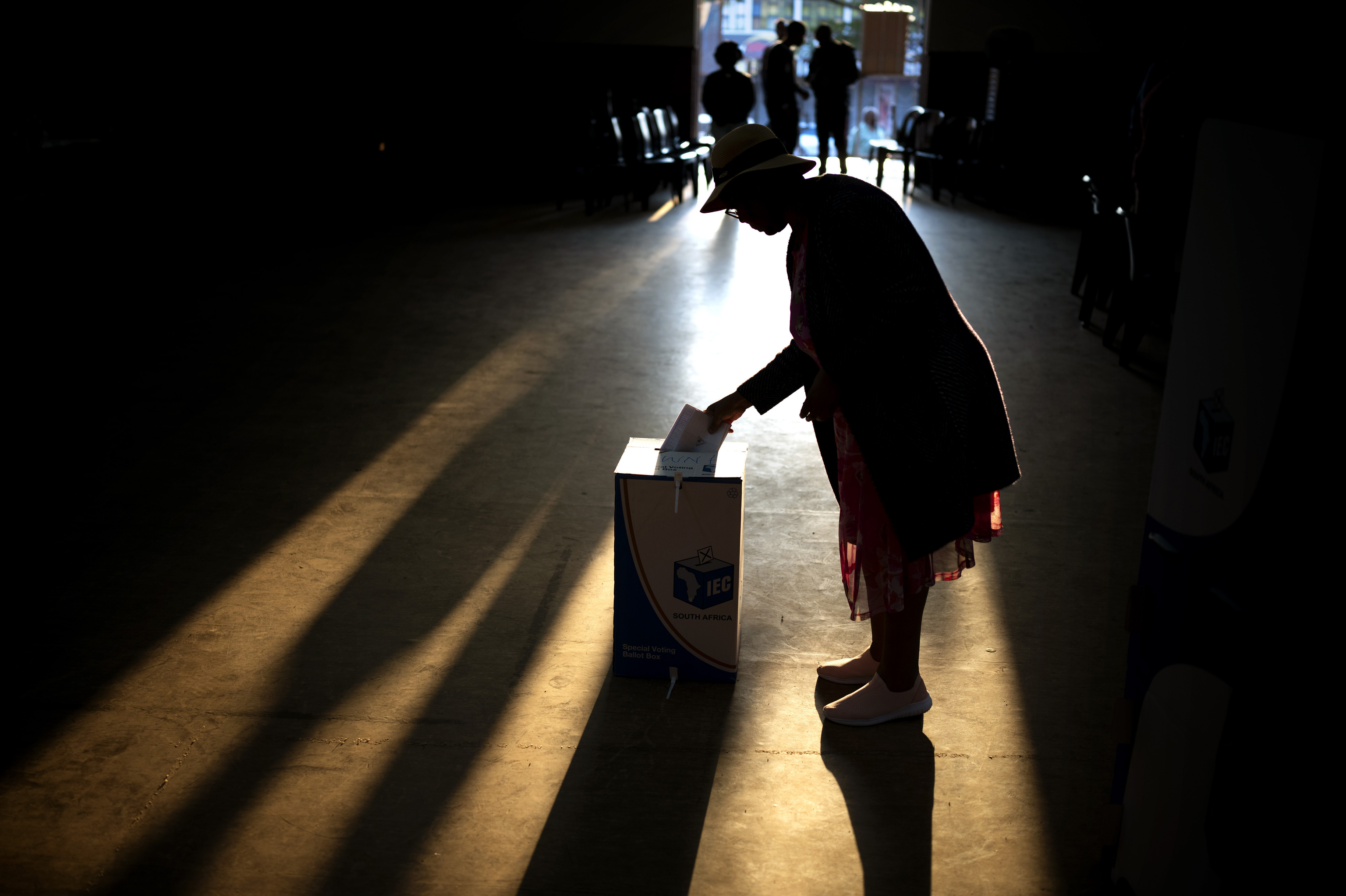 A woman casts her ballot at a polling station.