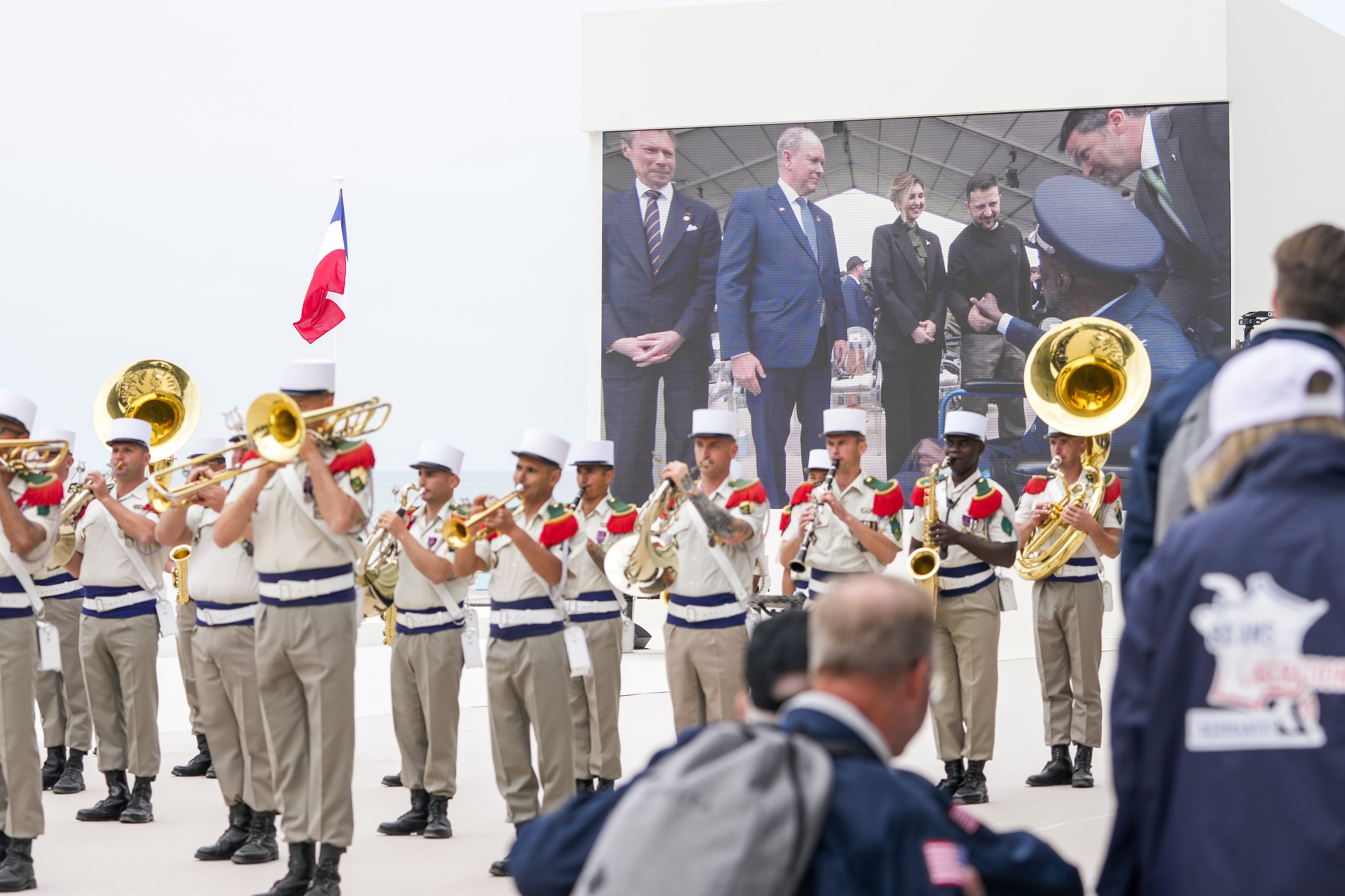 Shown in a big screen, U.S. World War II veteran Enoch "Woody" Woodhouse is greeted by Ukrainian President Volodymyr Zelenskyy prior to an international ceremony to mark the 80th anniversary of D-Day