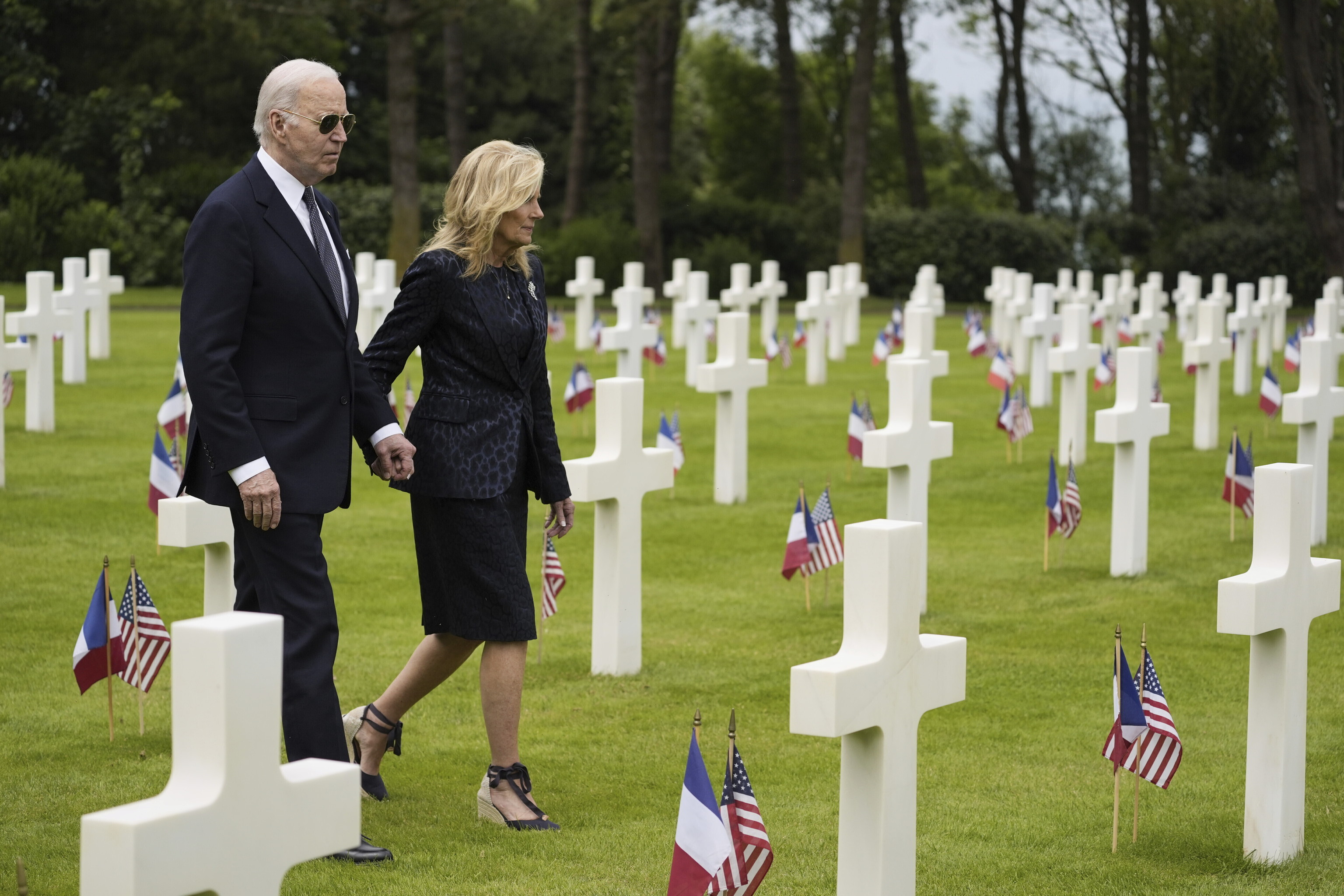 President Joe Biden and first lady Jill Biden walk in the Normandy American Cemetery