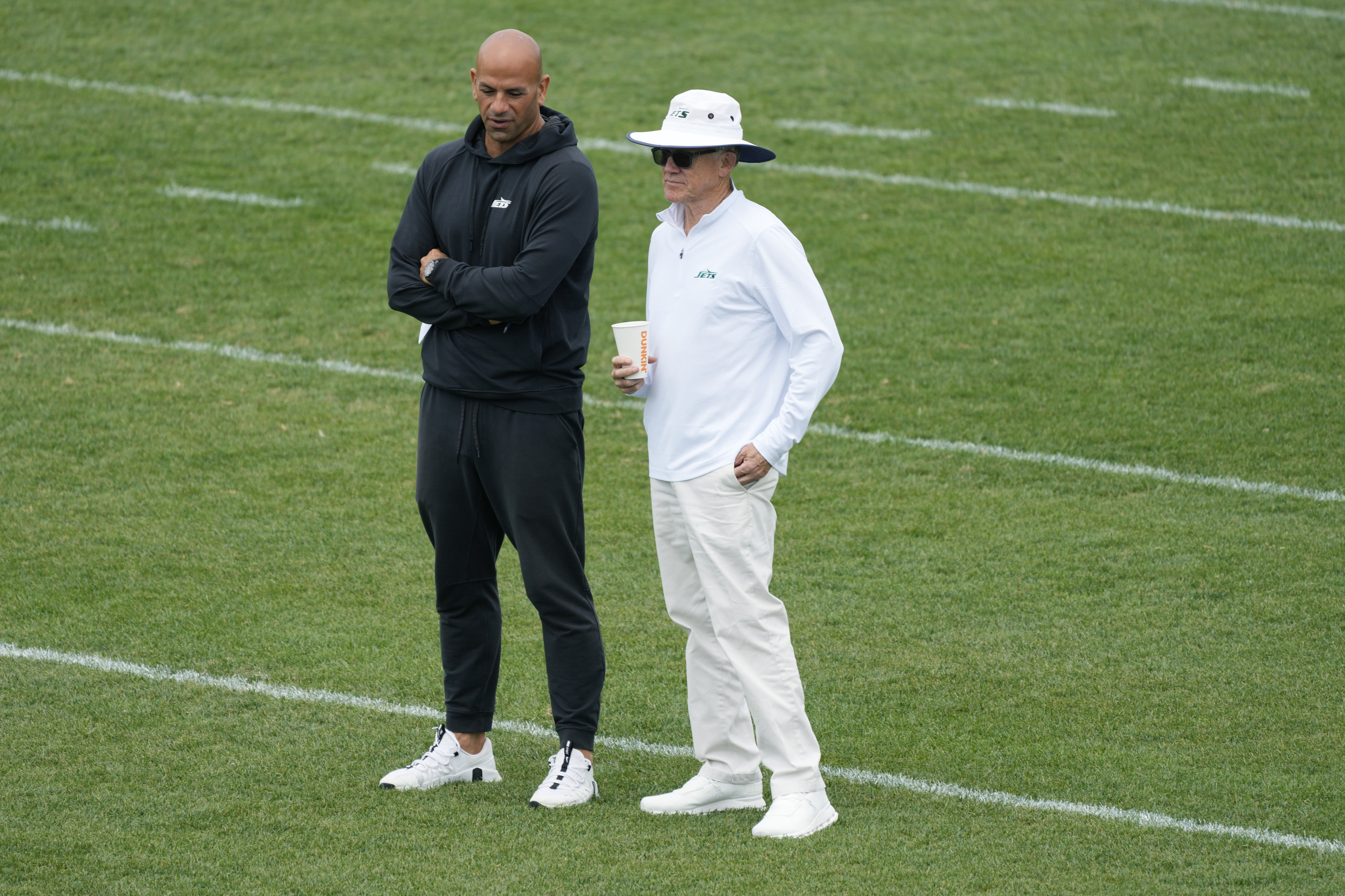 New York Jets head coach Robert Saleh, left, talks to team owner Woody Johnson.