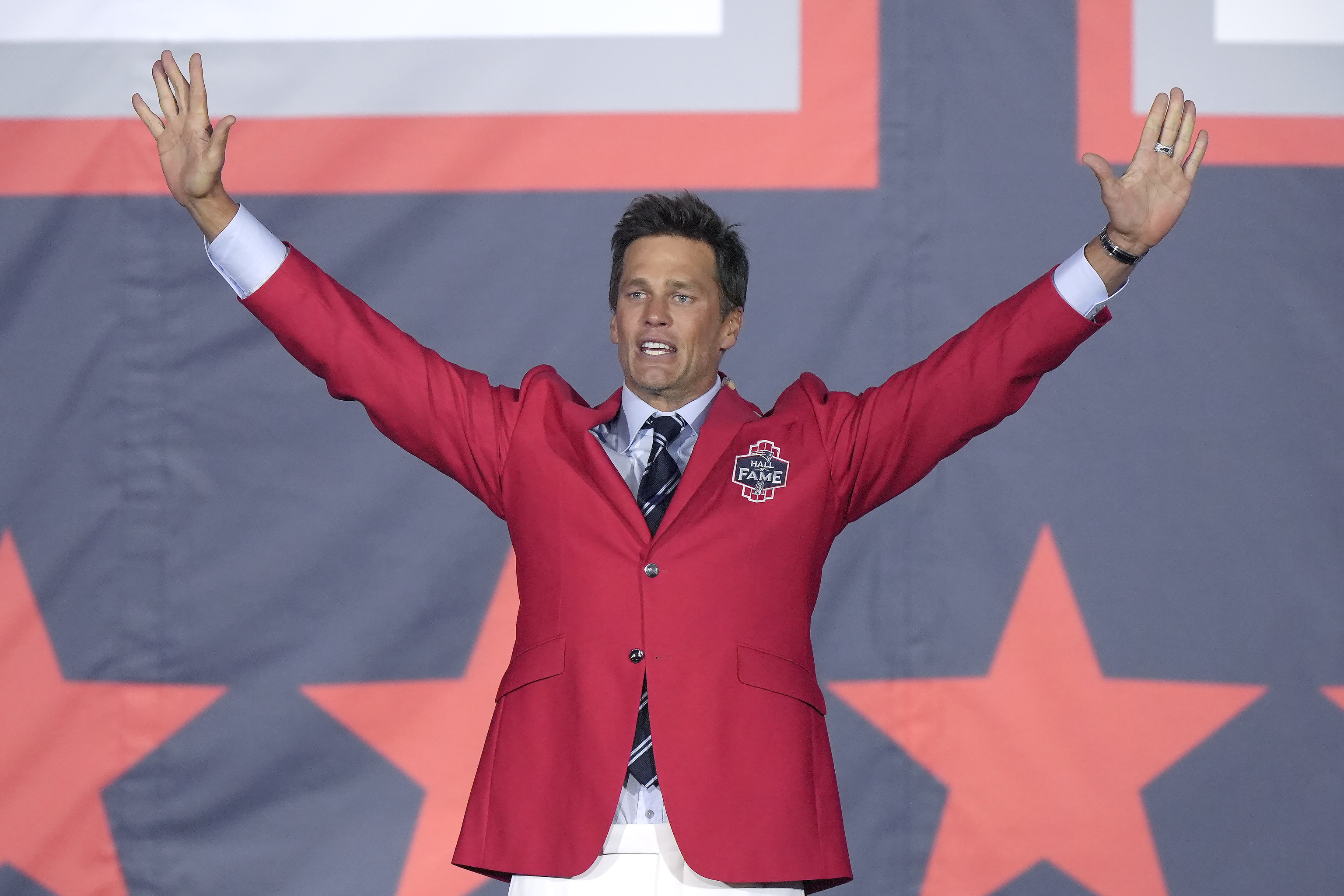 Former New England Patriots quarterback Tom Brady waves to the crowd.