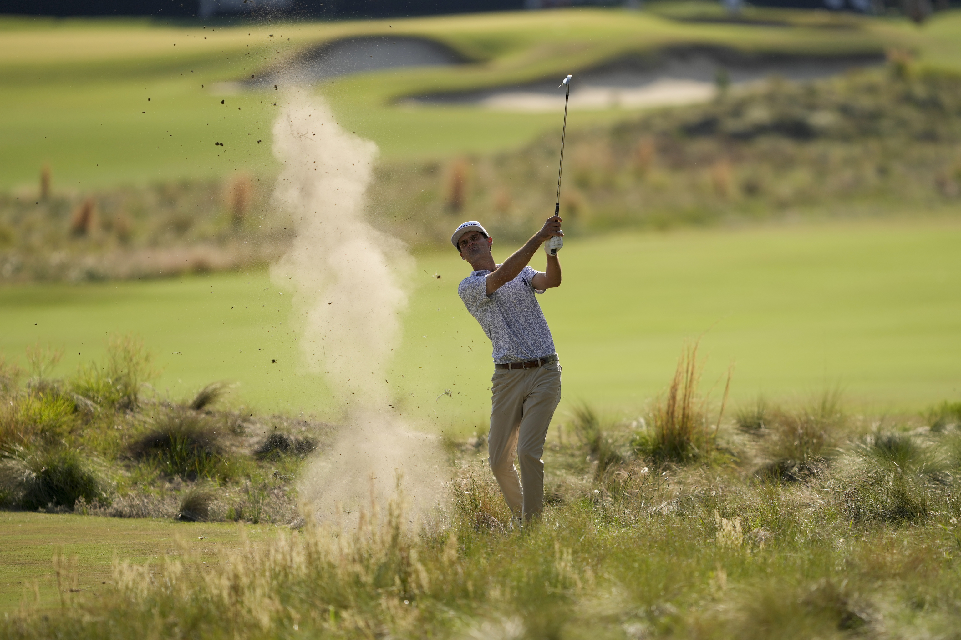 Jackson Suber hits from the native area on the 14th hole during the first round of the U.S. Open.