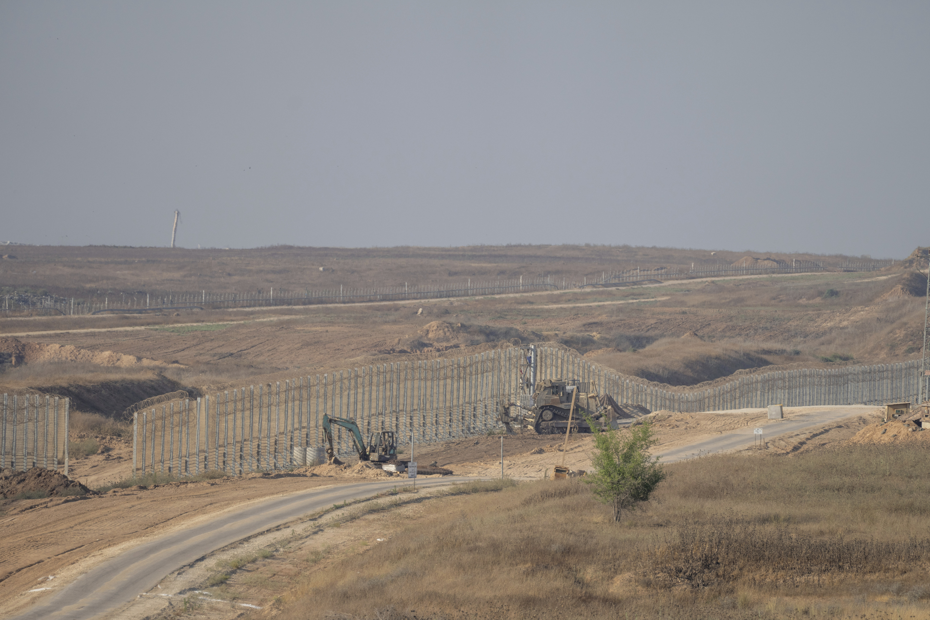 Israeli army bulldozers are seen near the Gaza Strip border.