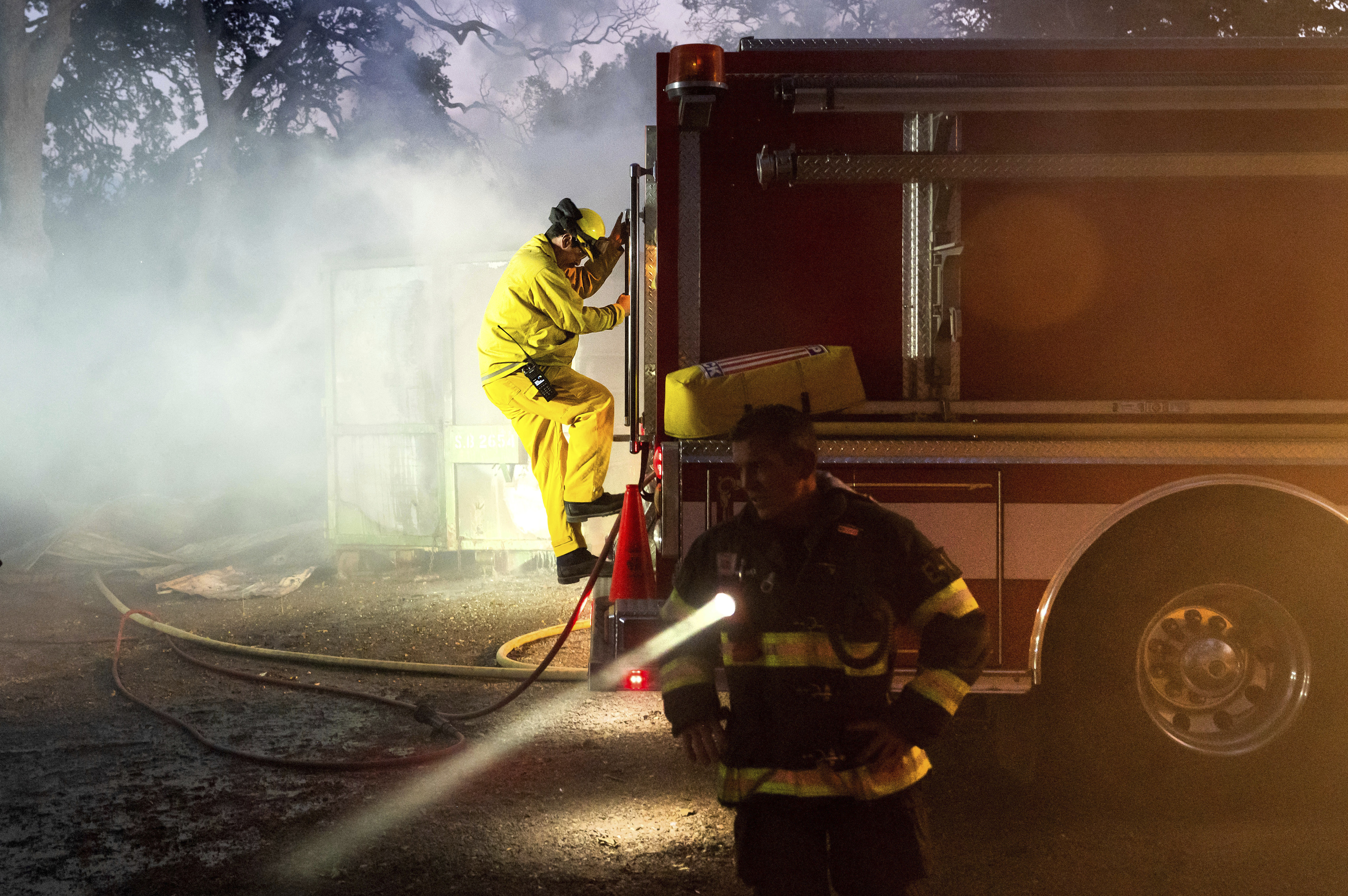 Firefighters battle the Point Fire burning along West Dry Creek Road in Healdsburg.