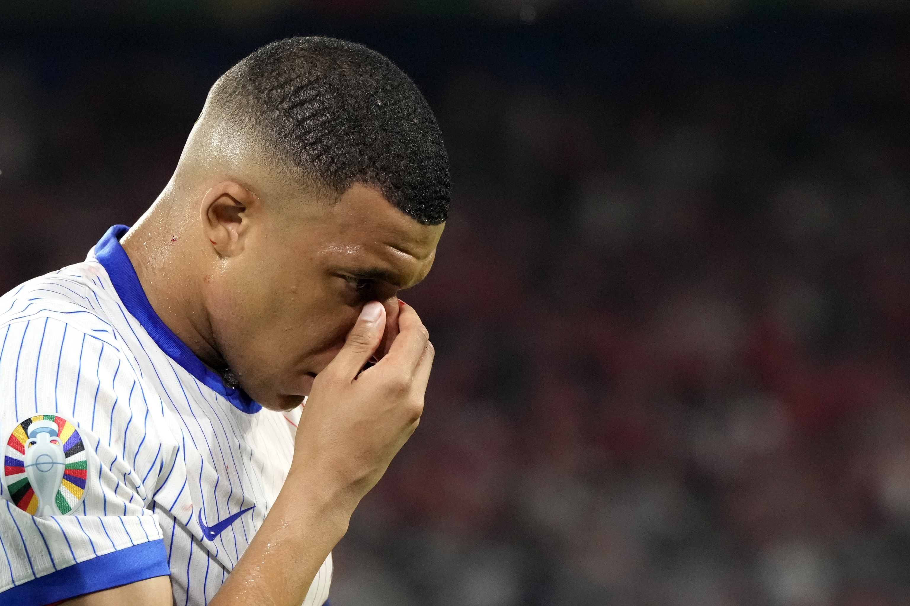 Mbappe holds his nose during match against Austria.