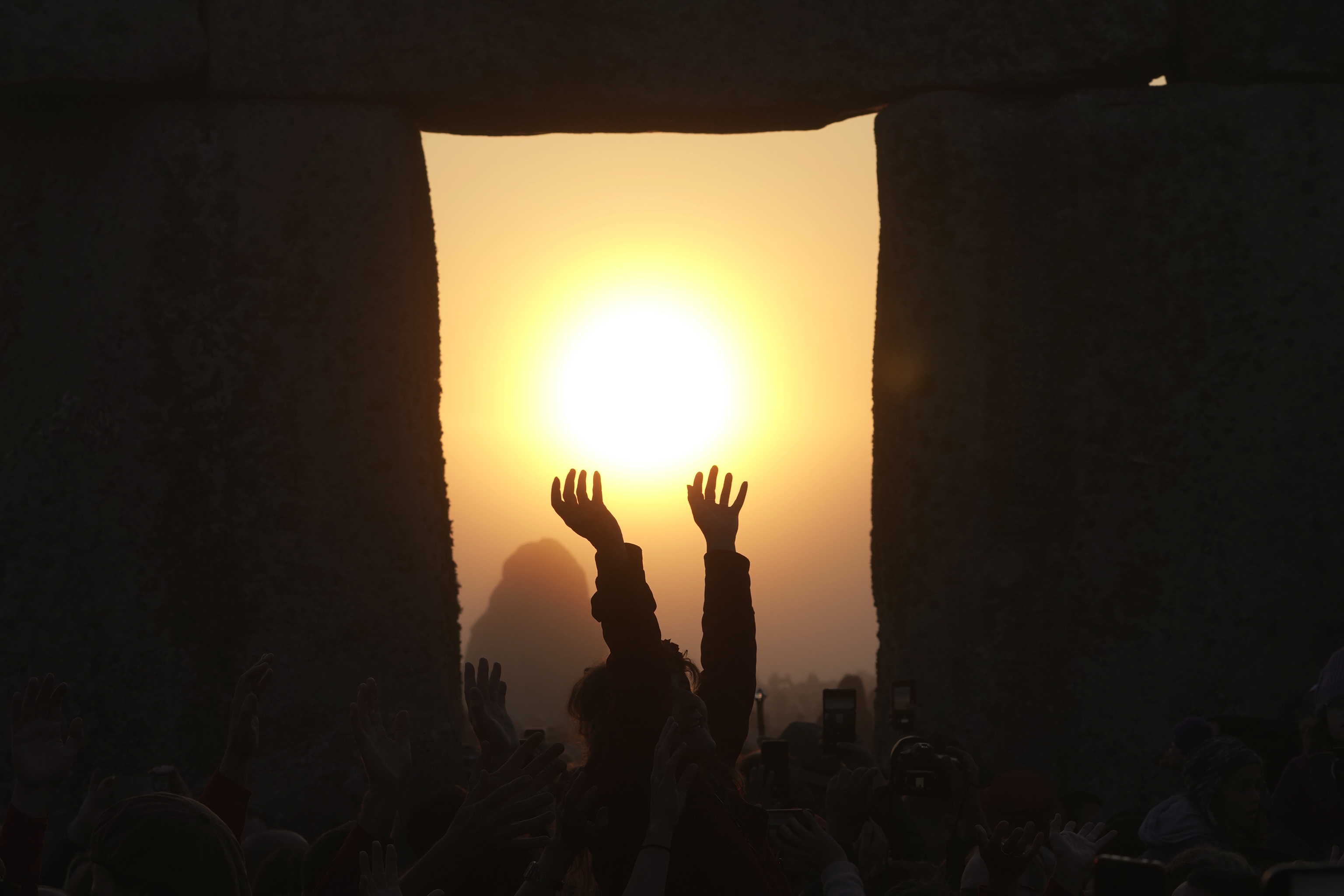 Revelers gather at the ancient stone circle Stonehenge.