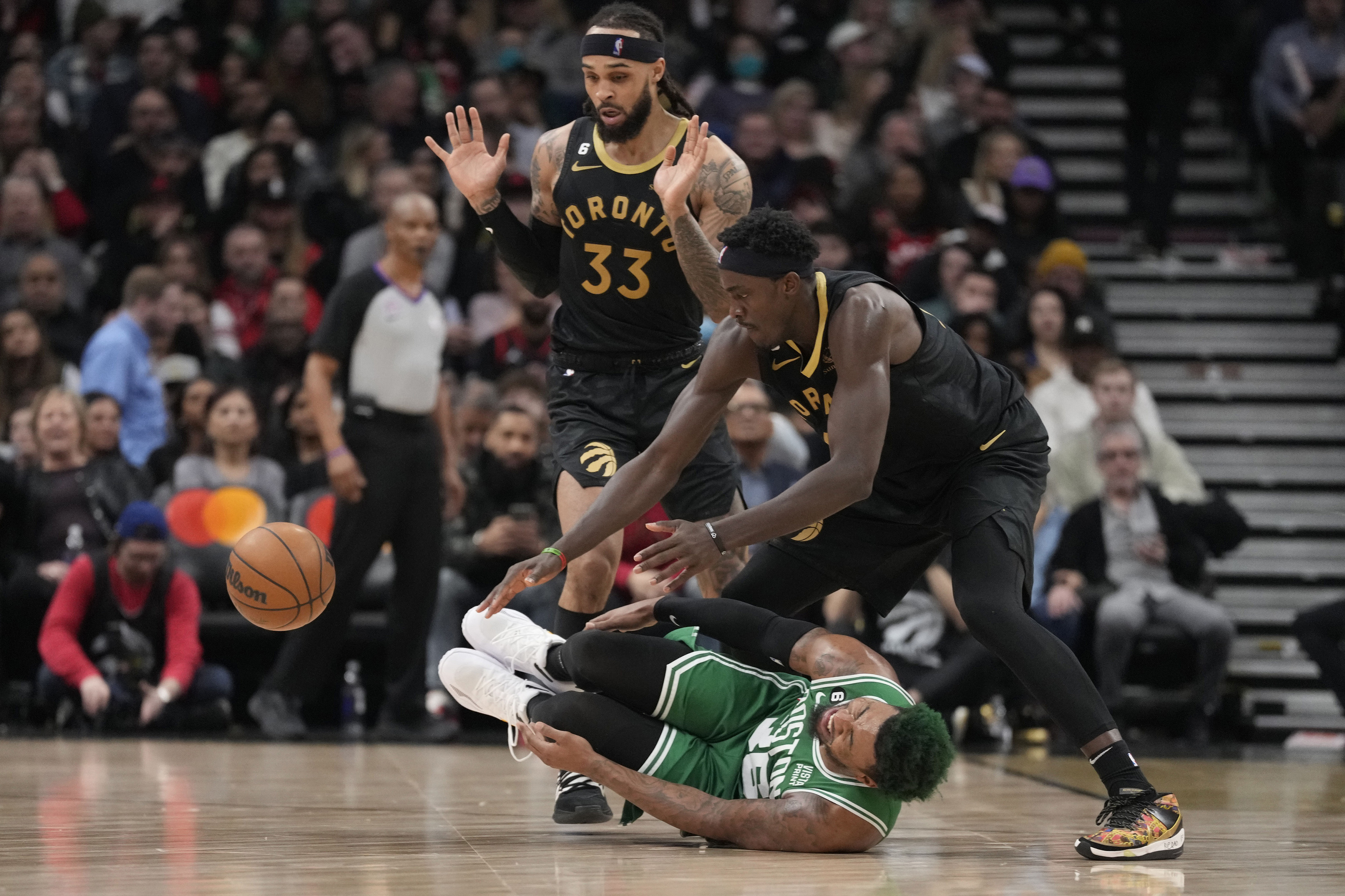 Boston Celtics guard Marcus Smart (36) rolls on the floor after an injury as Toronto Raptors forward Pascal Siakam.