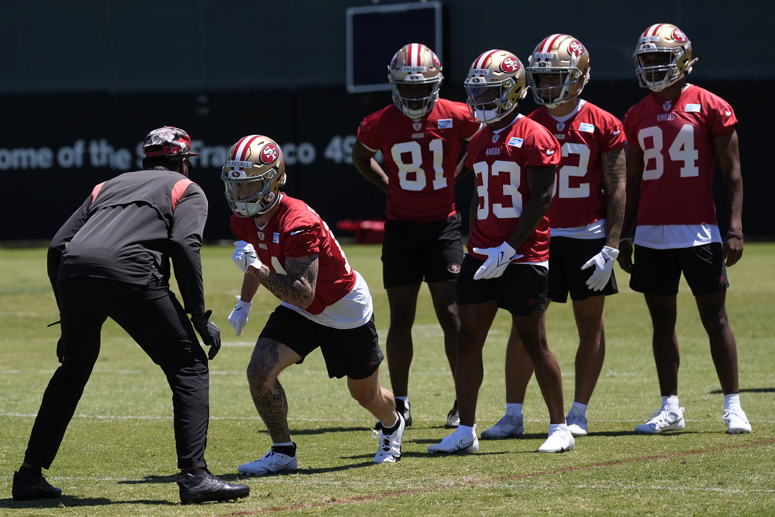 San Francisco 49ers wide receiver Ricky Pearsall, second from left, takes part in drills.