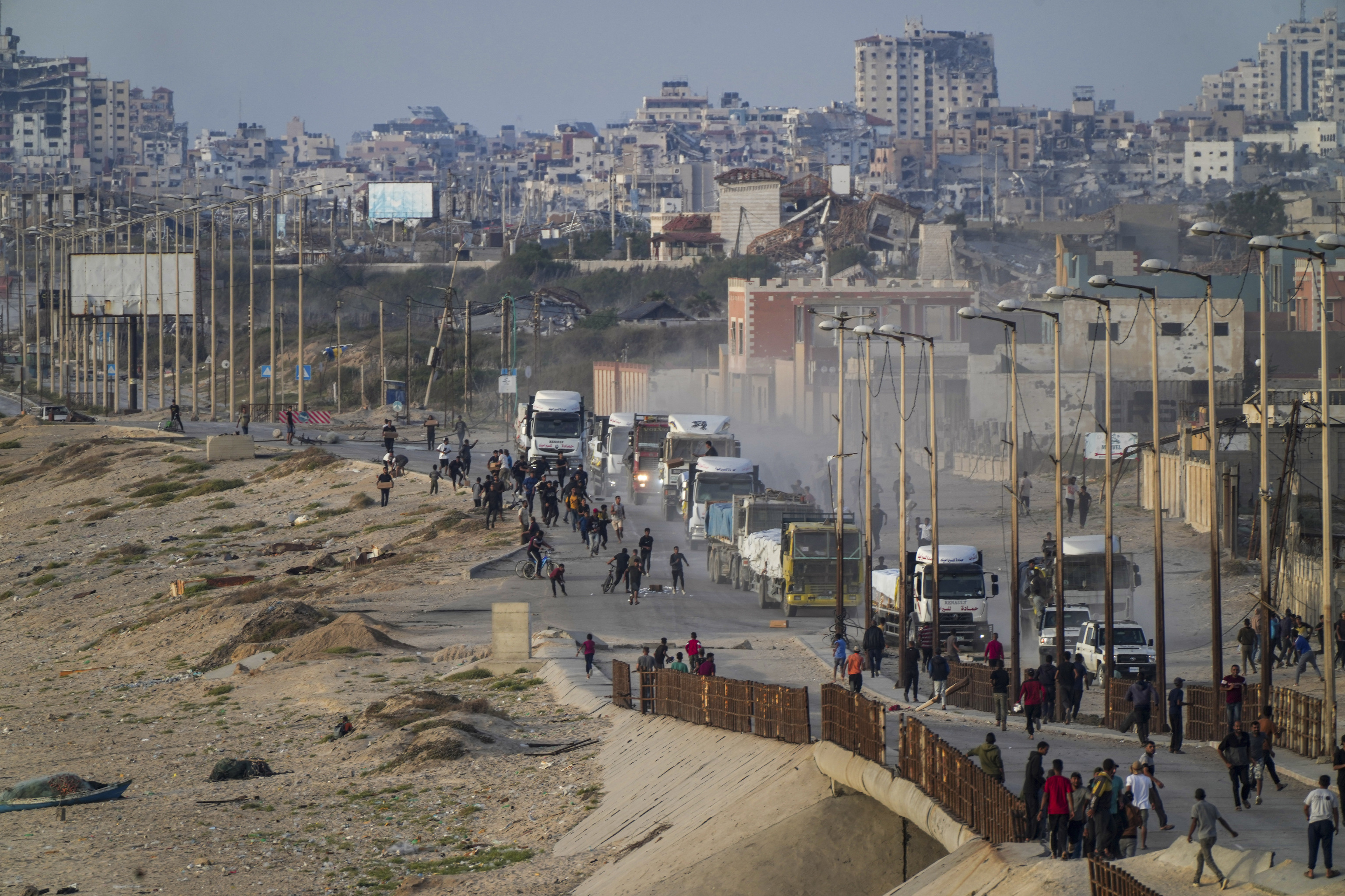 Palestinians storm rucks loaded with humanitarian aid brought in through a new U.S.-built pier.