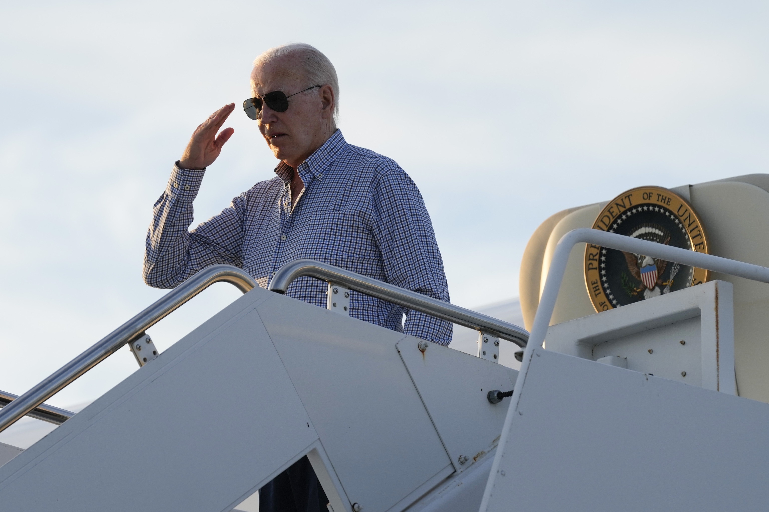 President Joe Biden salutes as he boards Air Force One.