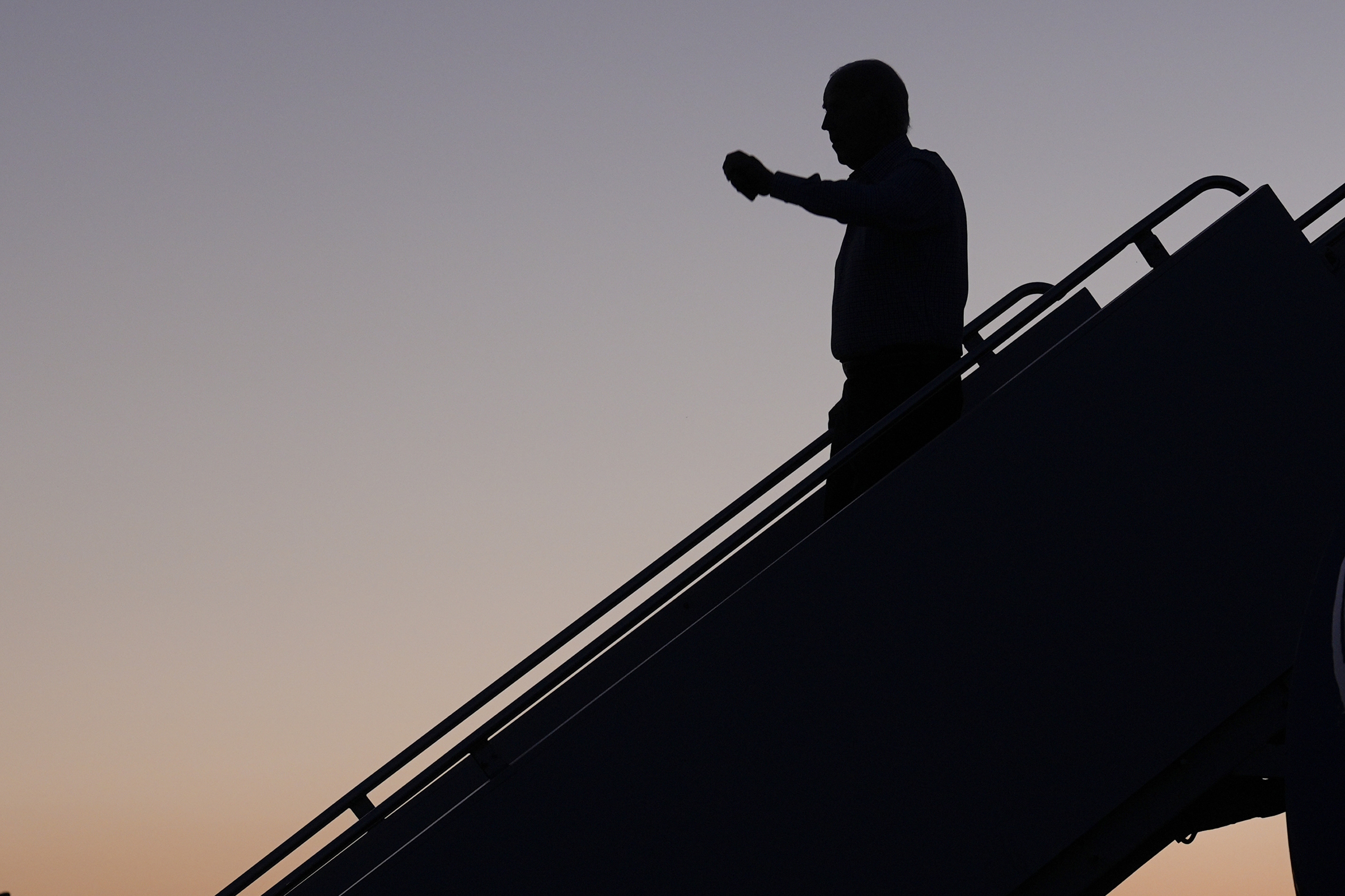 President Joe Biden waves as he arrives on Air Force One.