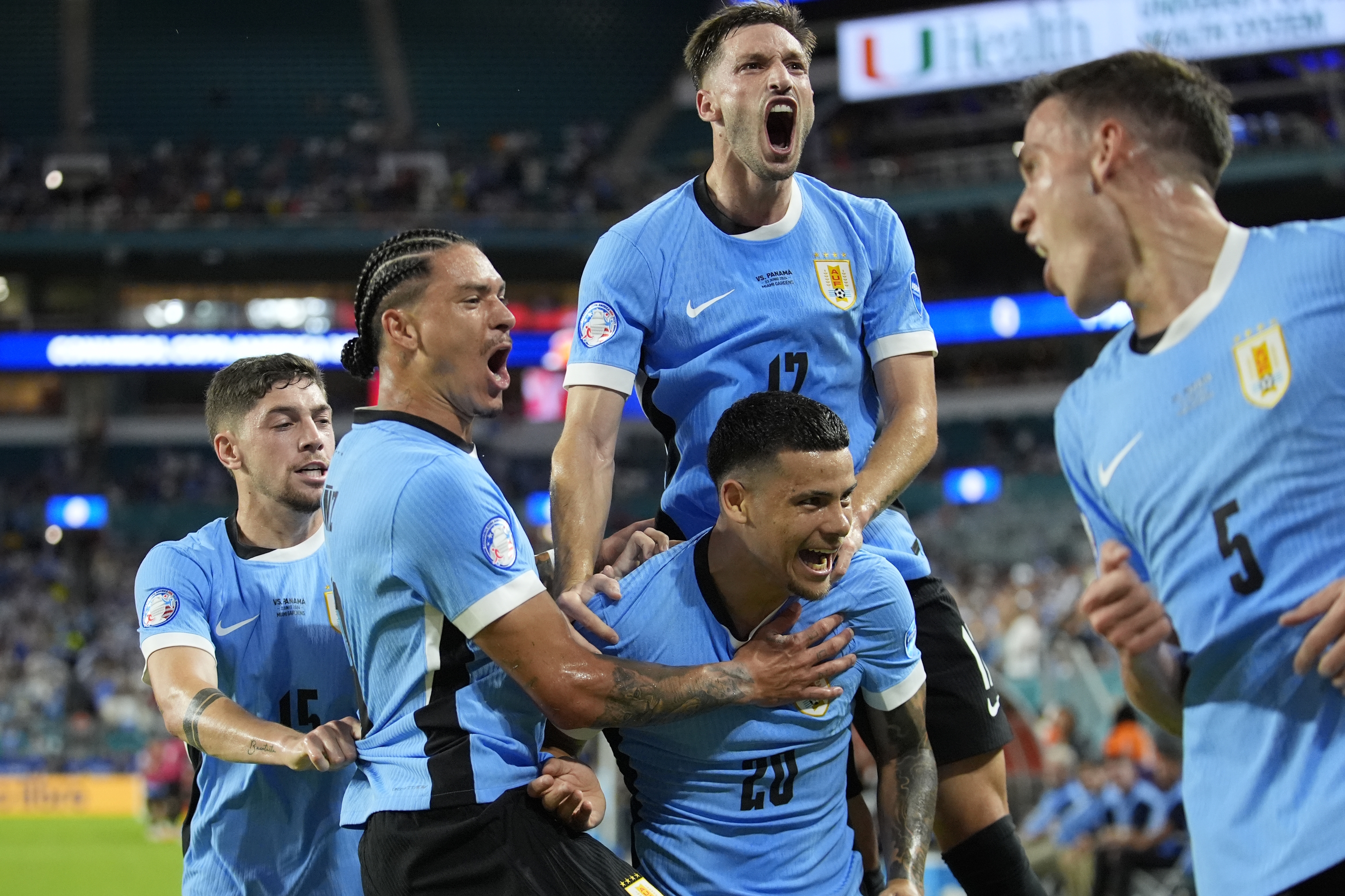 Uruguay's Araujo celebrates with teammates after scoring.AP