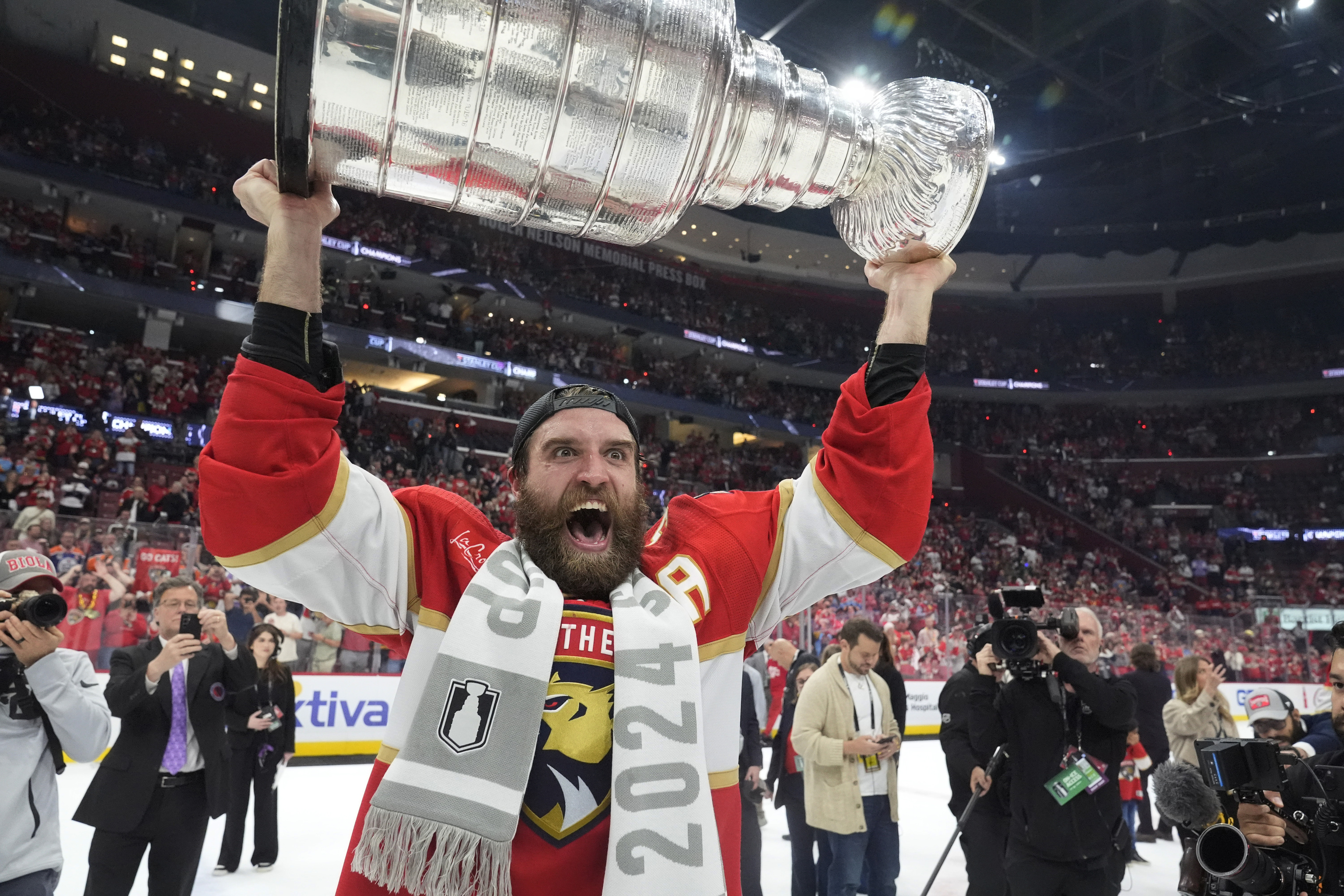 Panthers' Aaron Ekblad lifts the Stanley Cup trophy.