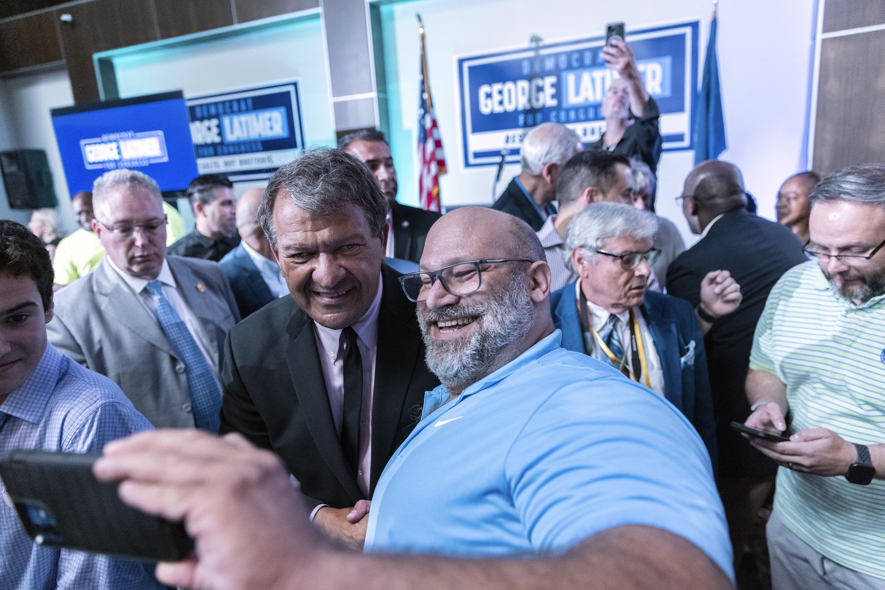 Latimer celebrates with supporters at an election party.