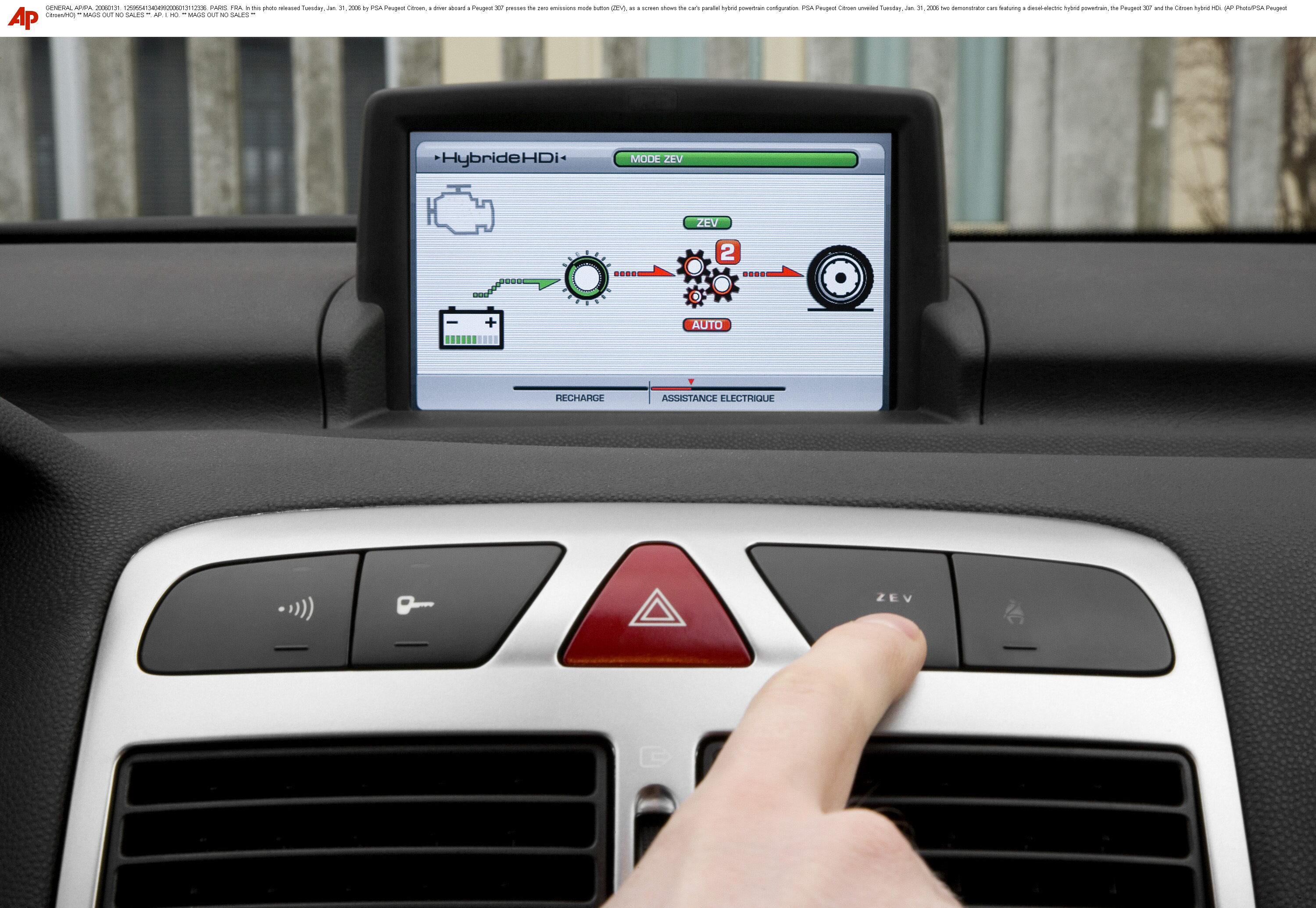 a driver aboard a Peugeot 307 presses the zero emissions mode button