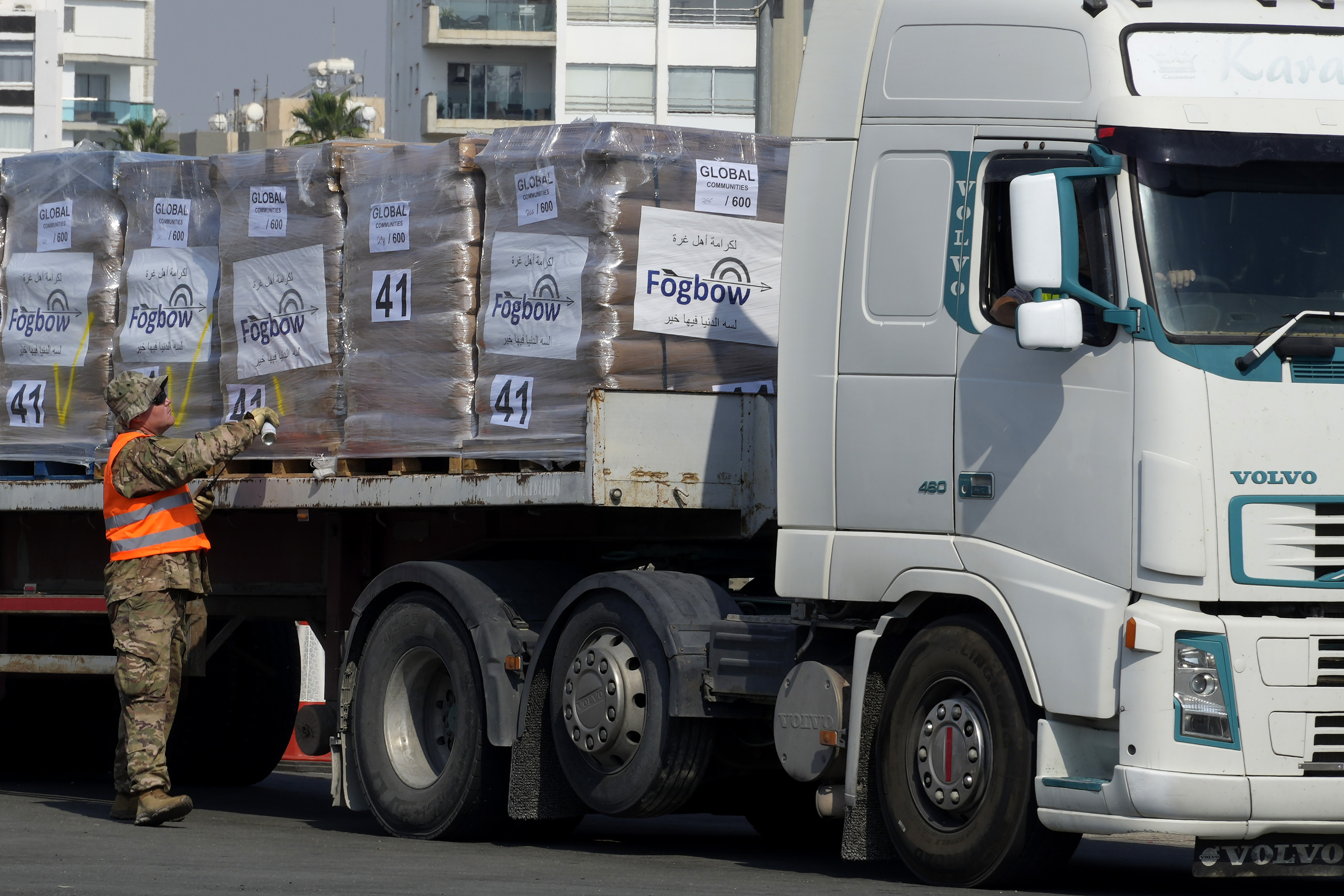 A U.S soldier inspects Gaza aid on a truck.