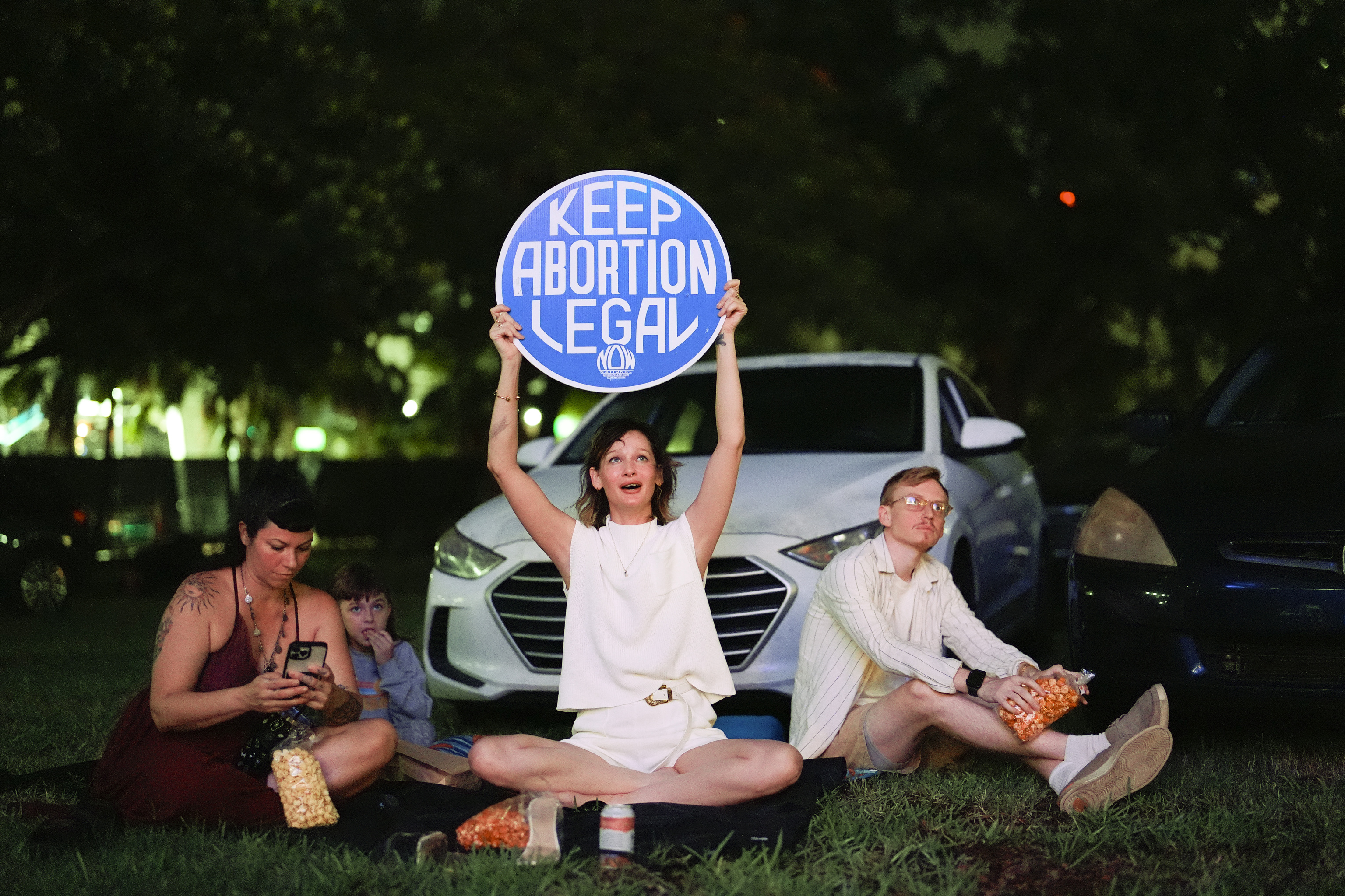 Reproductive rights advocate Kat Duesterhaus holds up a sign as U.S. President Joe Biden