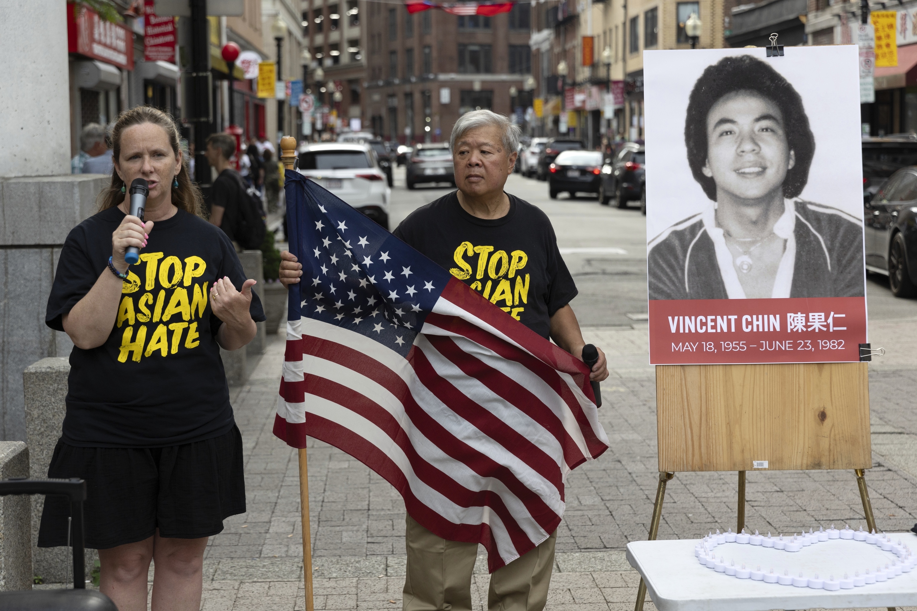 Wilson Lee holds an U.S. flag as Boston City Councilor Erin Murphy speaks during a remembrance ceremony for Vincent Chin in Chinatown