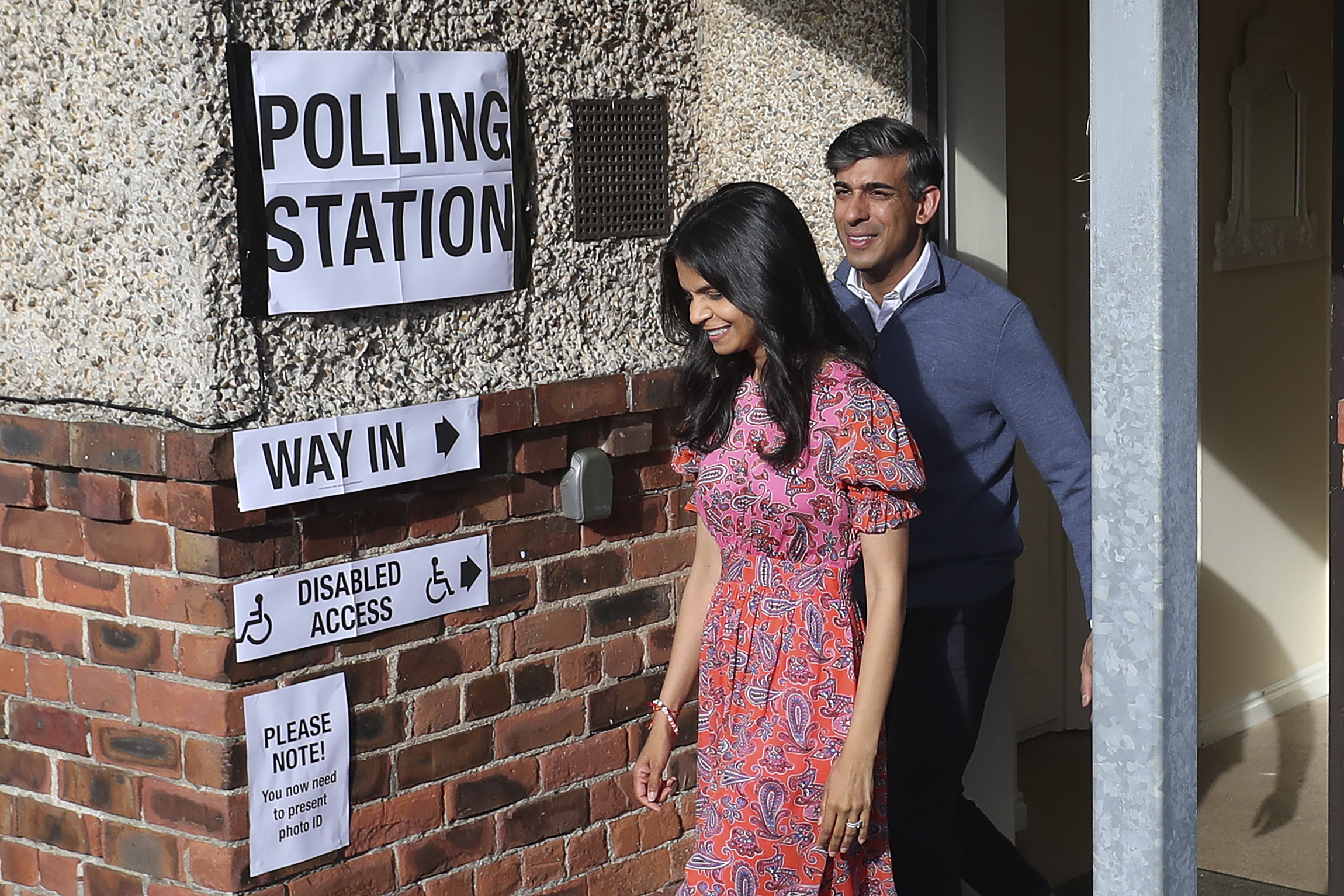 Britain's Prime Minister Rishi Sunak and his wife Akshata Murty leave a polling station.