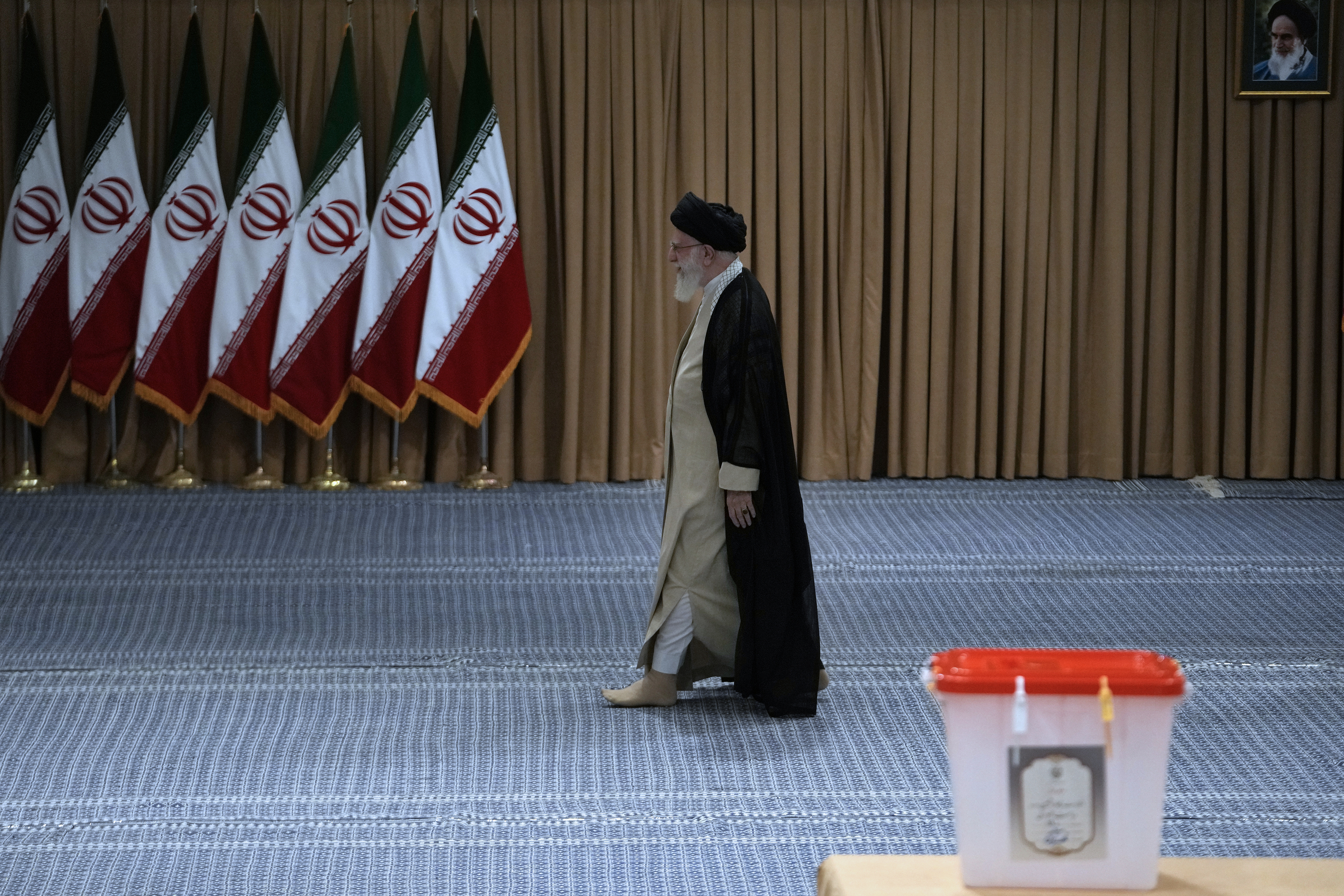 Iranian Supreme Leader Ayatollah Ali Khamenei arrives to vote.