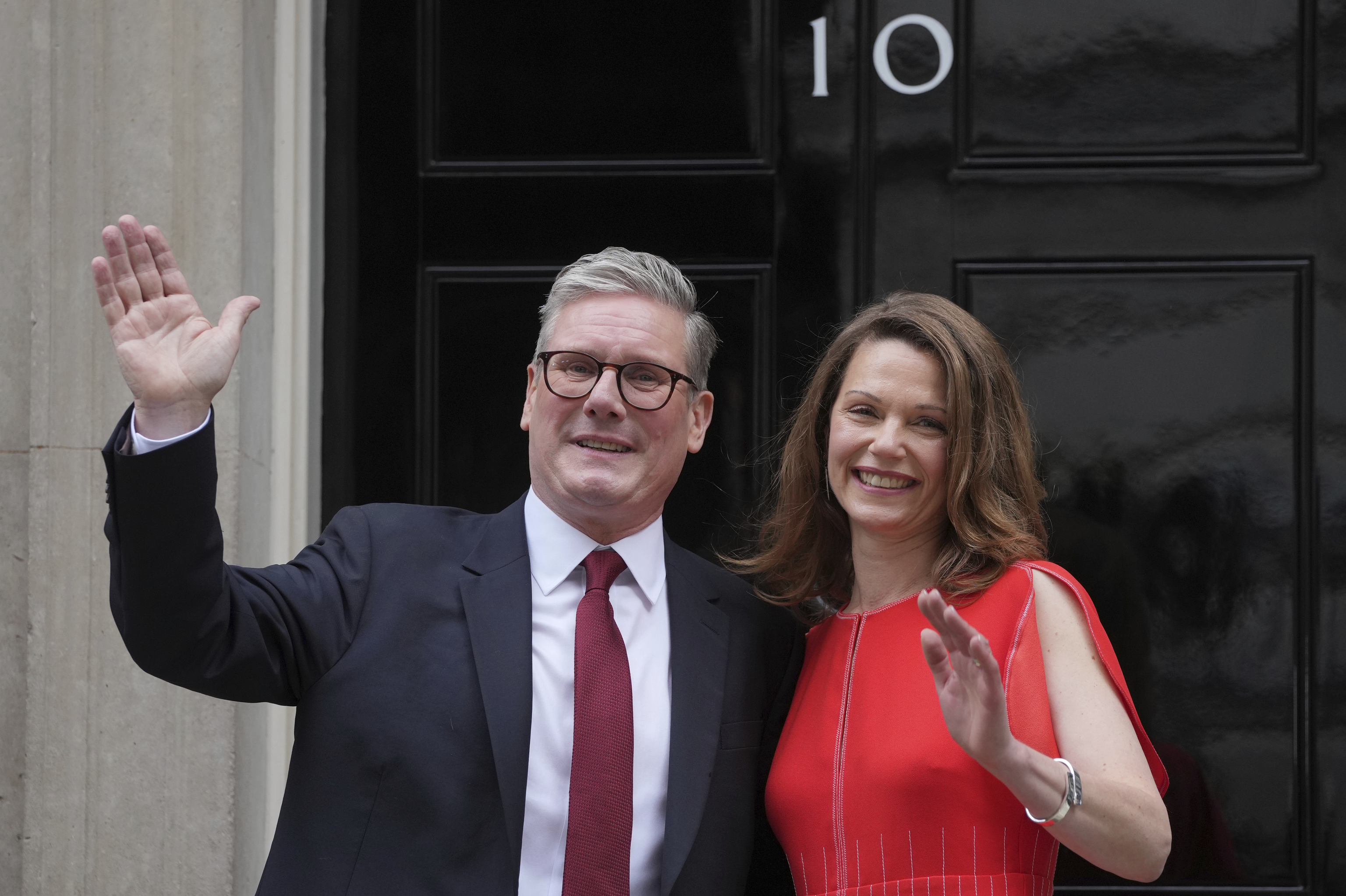 Starmer and his wife Victoria wave to supporters.