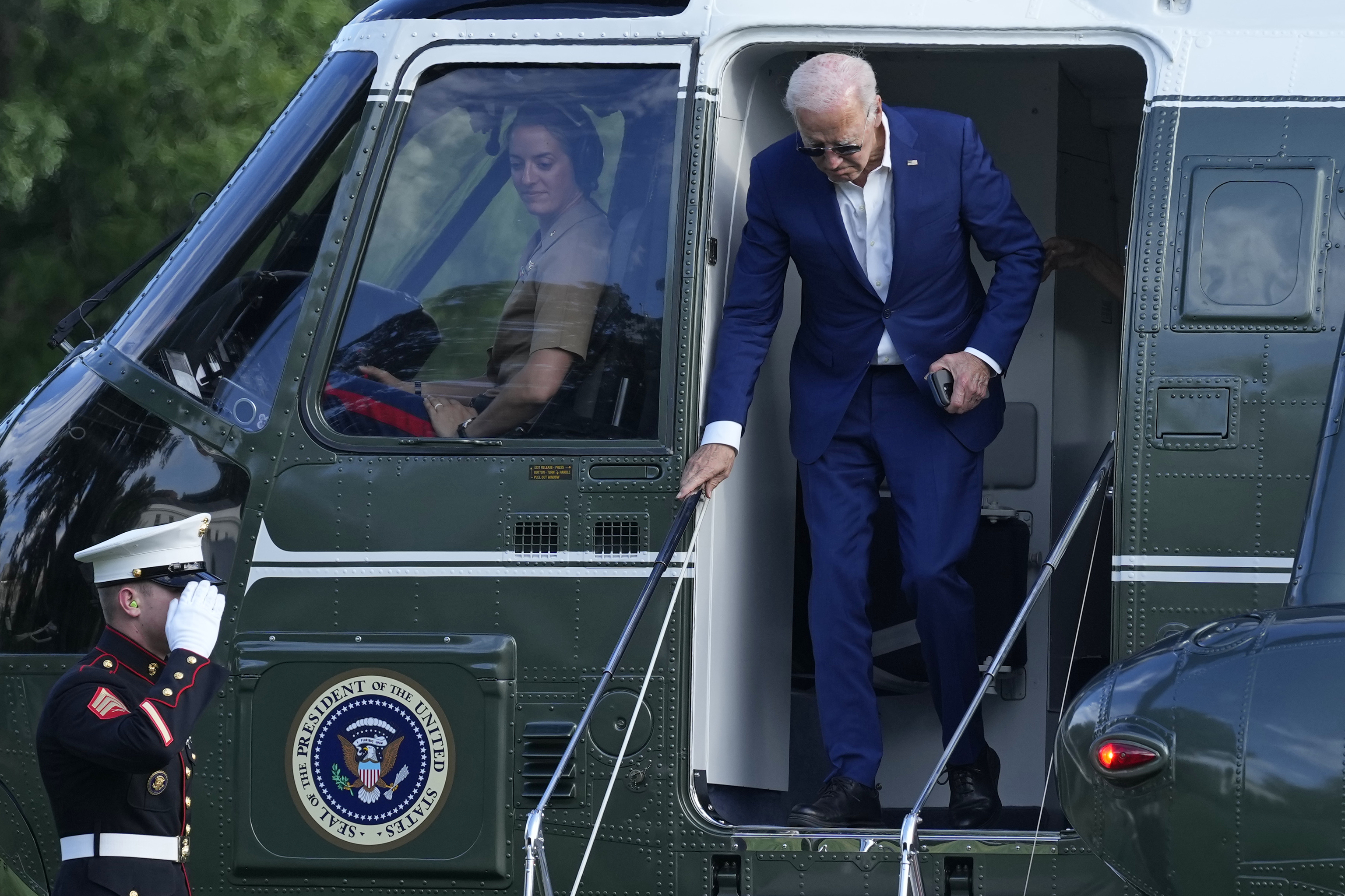 President Joe Biden walks off of Marine One on the South Lawn of the White House in Washington.