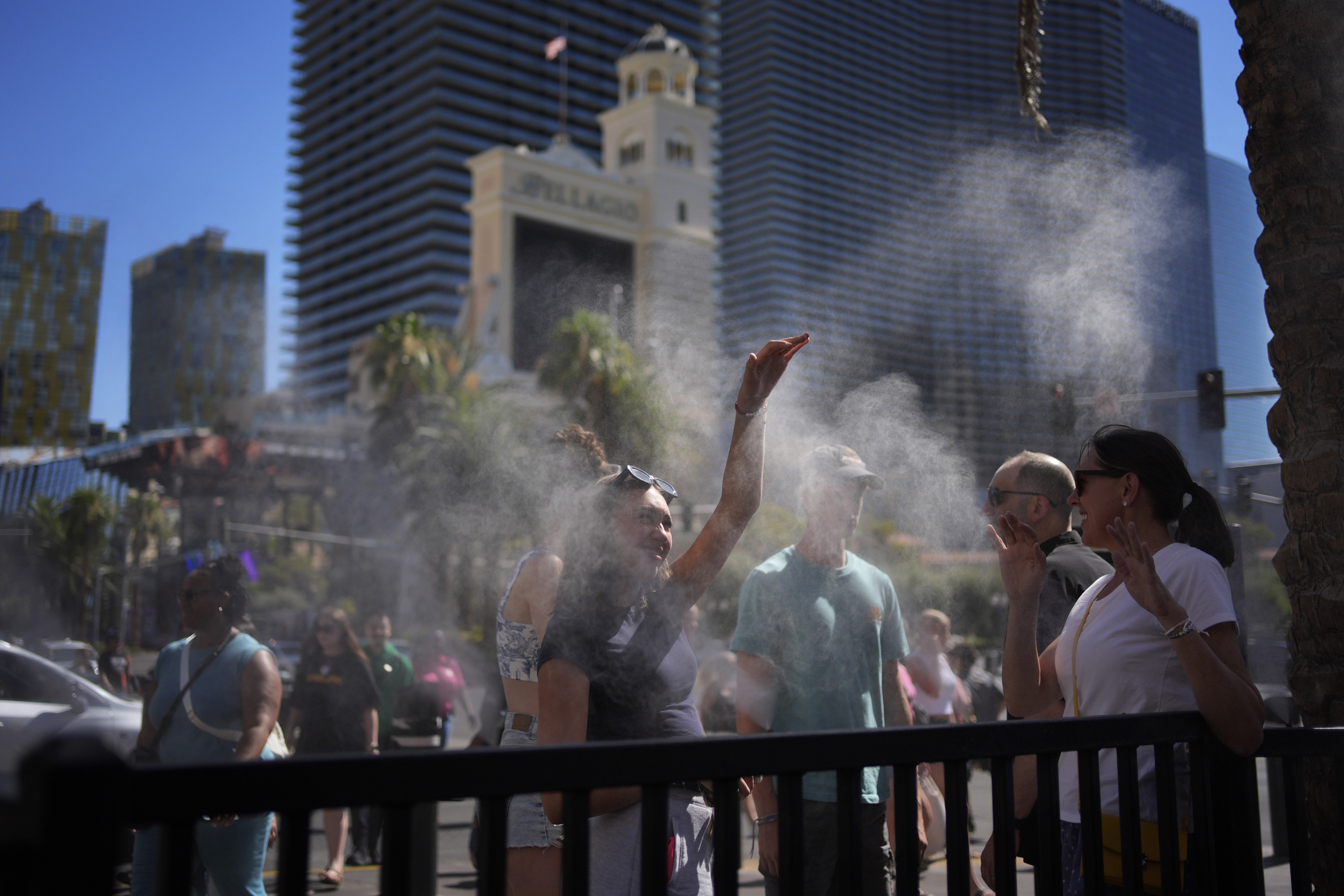 People cool off in misters along the Las Vegas Strip.