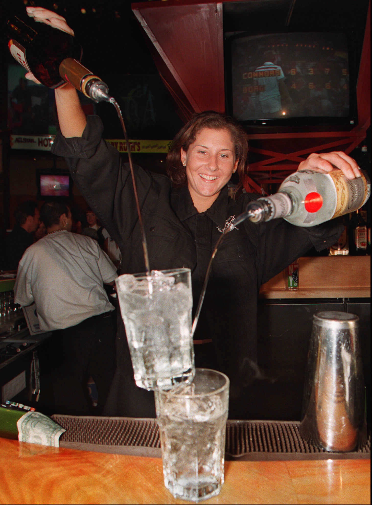 A waitress making a cocktail in a New York bar